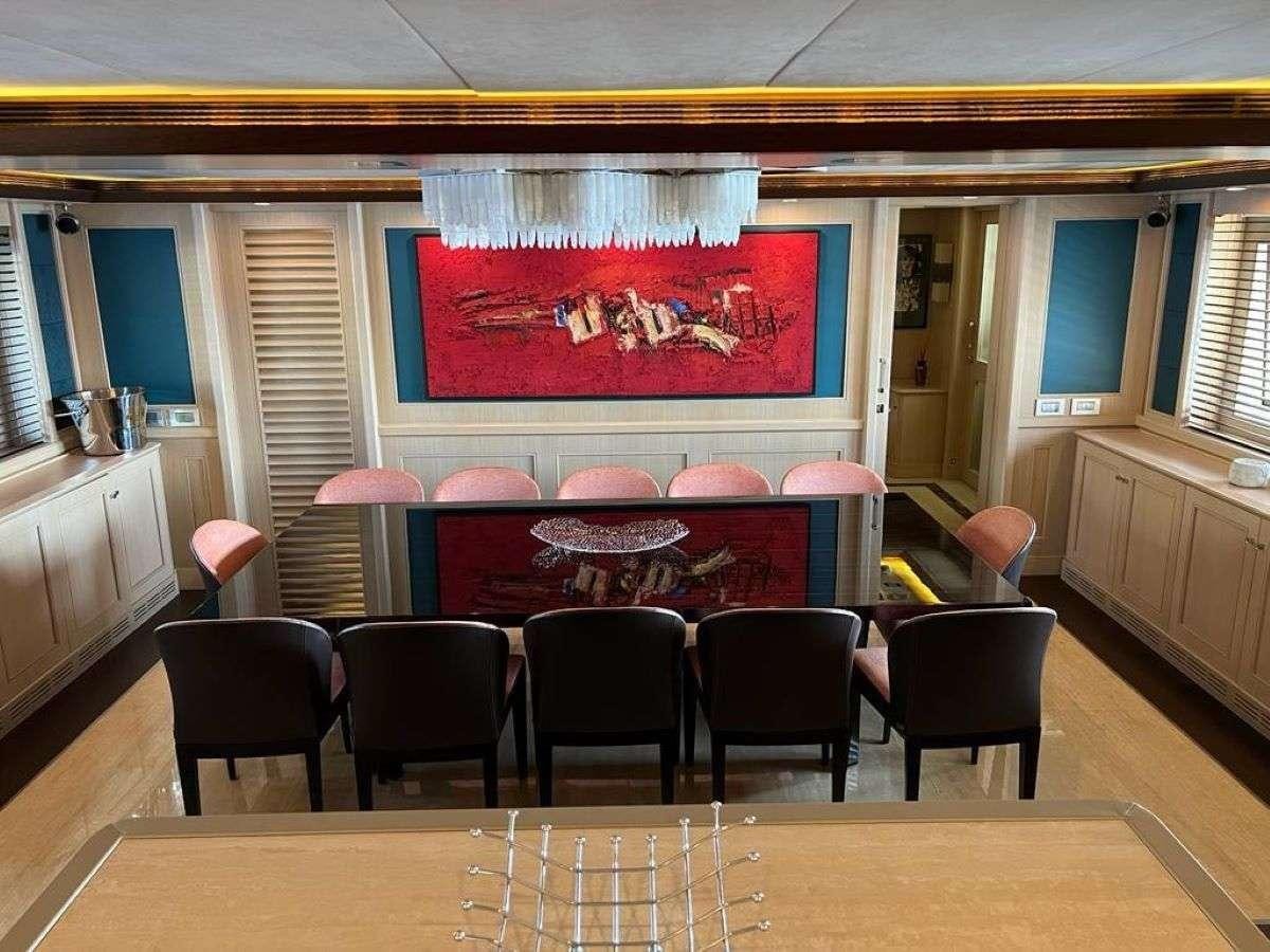 a room with tables and chairs aboard POLARIS Yacht for Charter