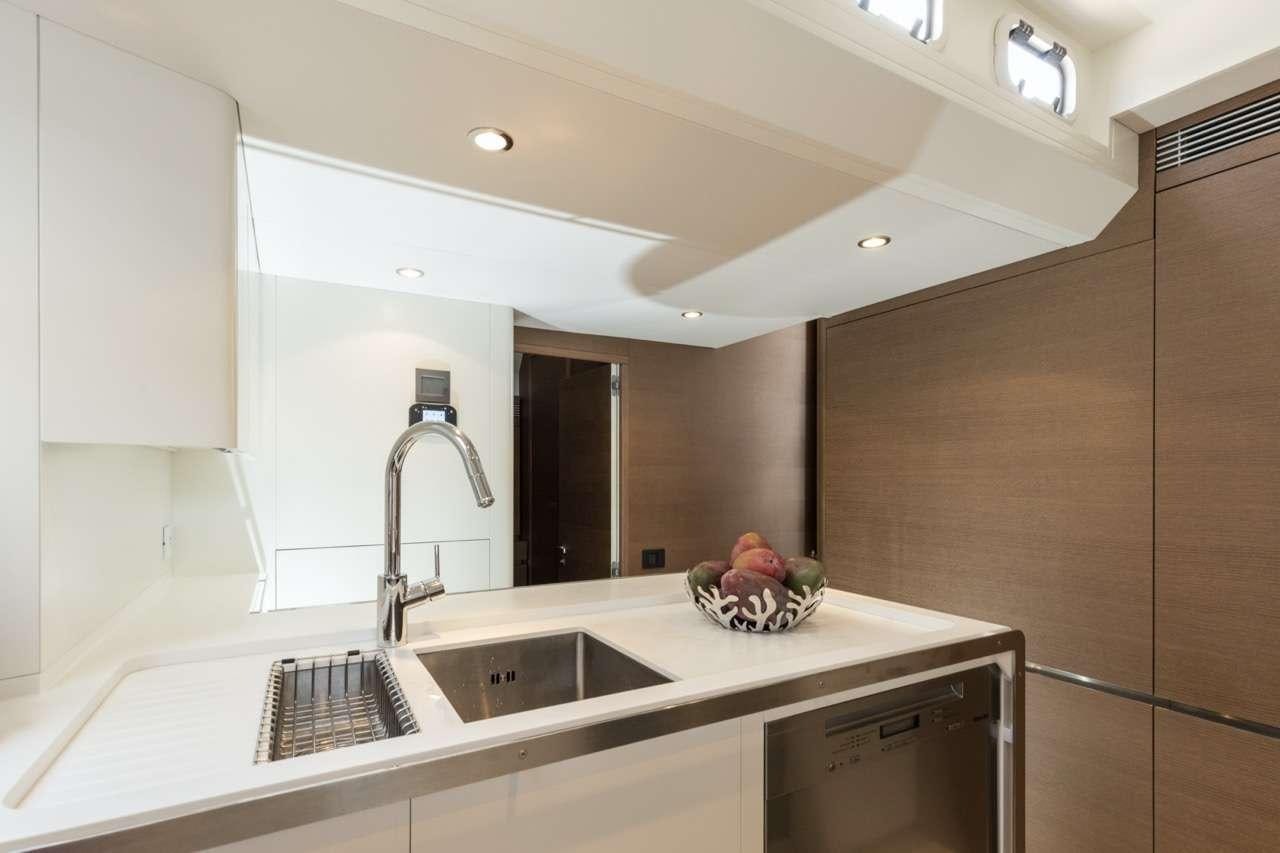 a kitchen with a sink and a large window aboard CNB 76 2017 Yacht for Charter