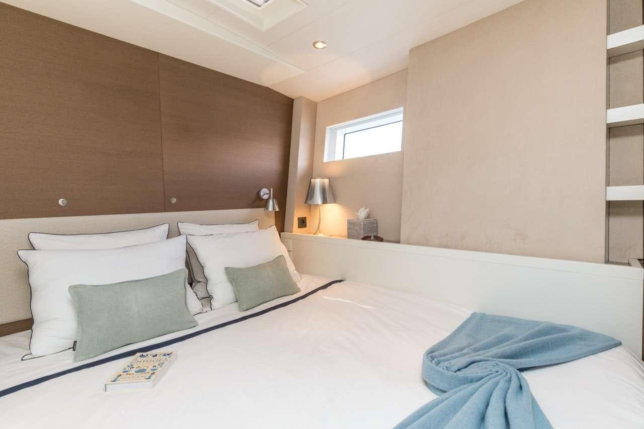 a bed with pillows aboard CNB 76 2017 Yacht for Charter