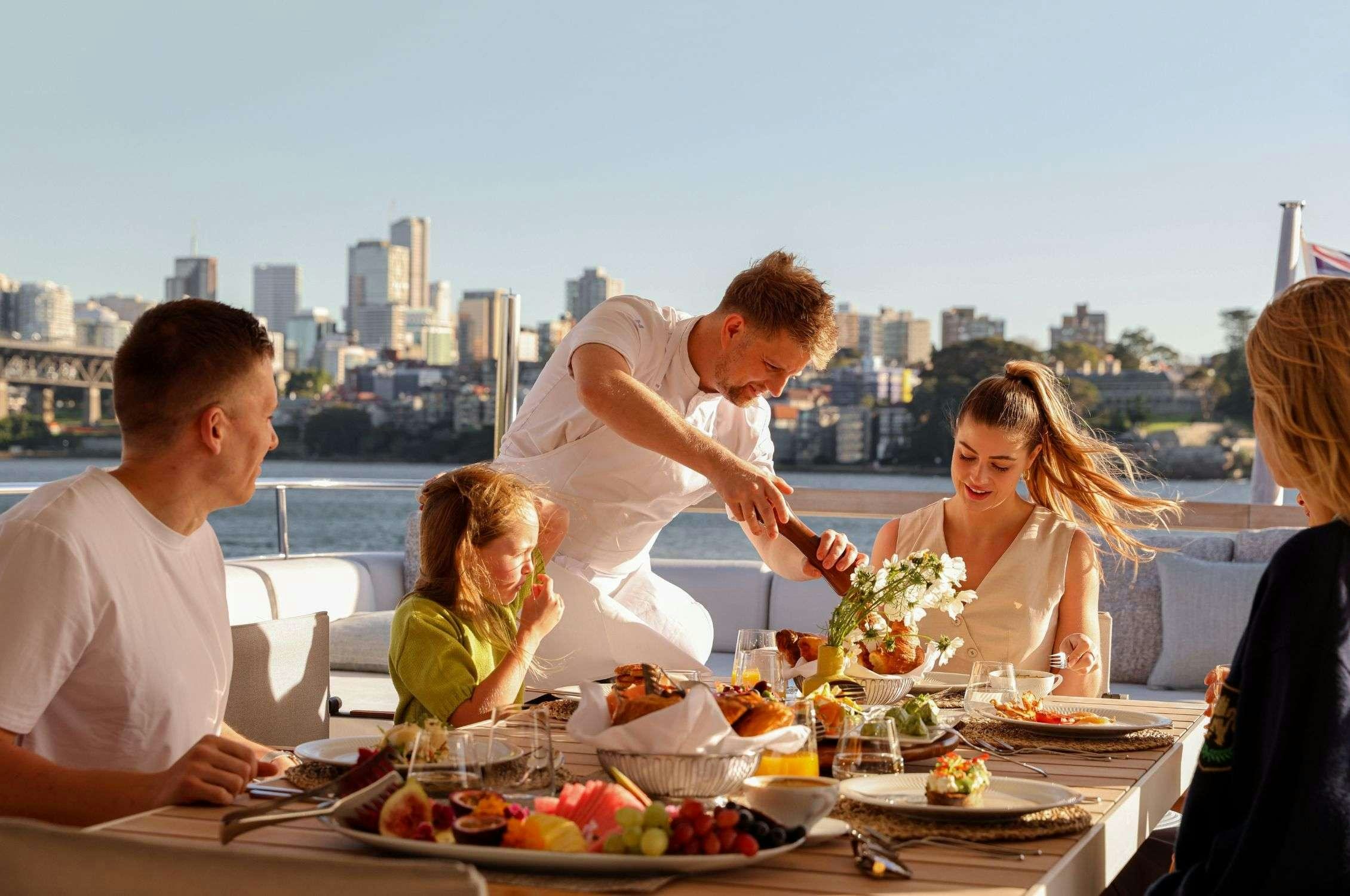 a family eating at a table aboard LANCE Yacht for Charter