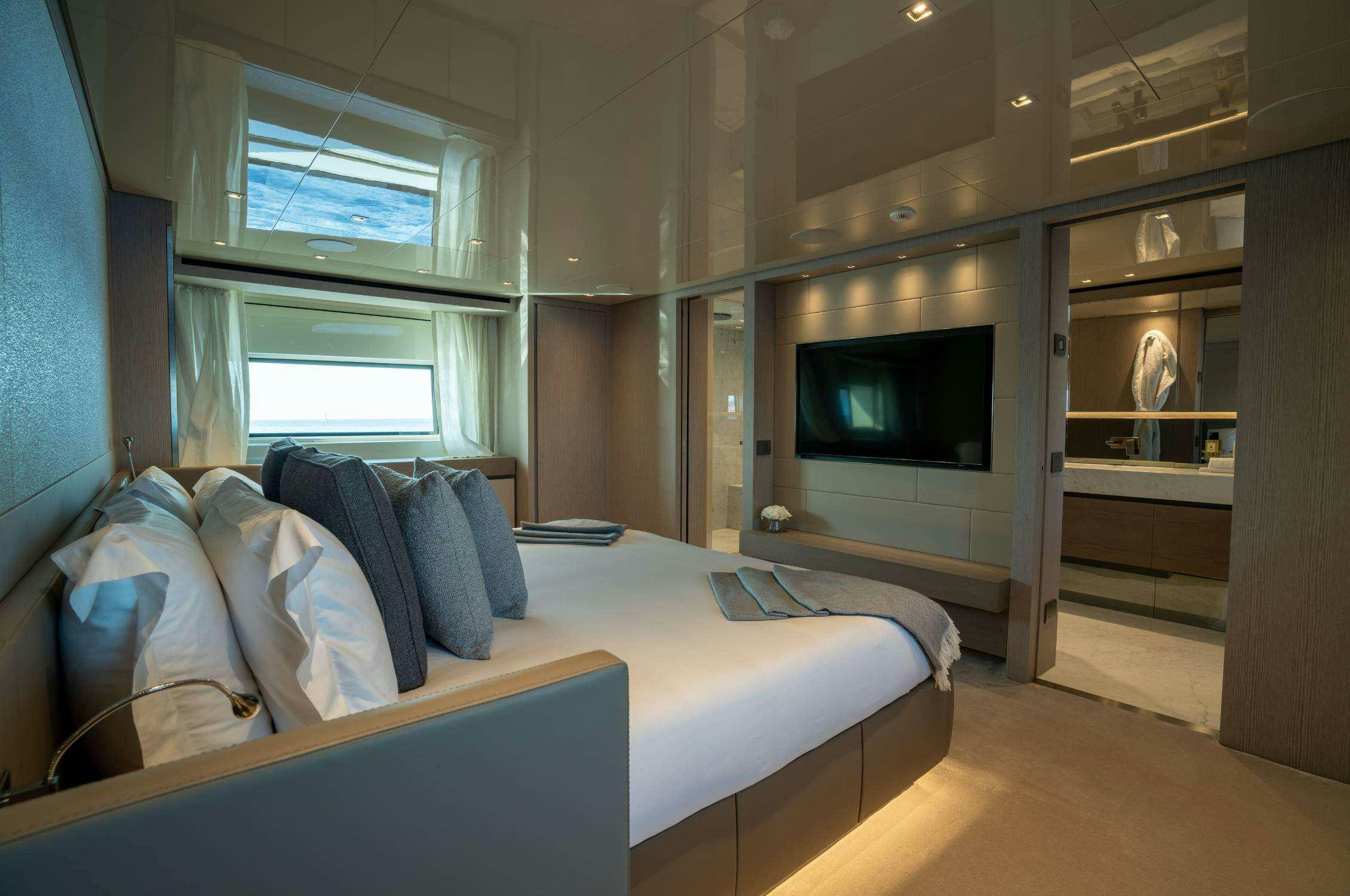 a bedroom with a bed and a television aboard LANCE Yacht for Charter