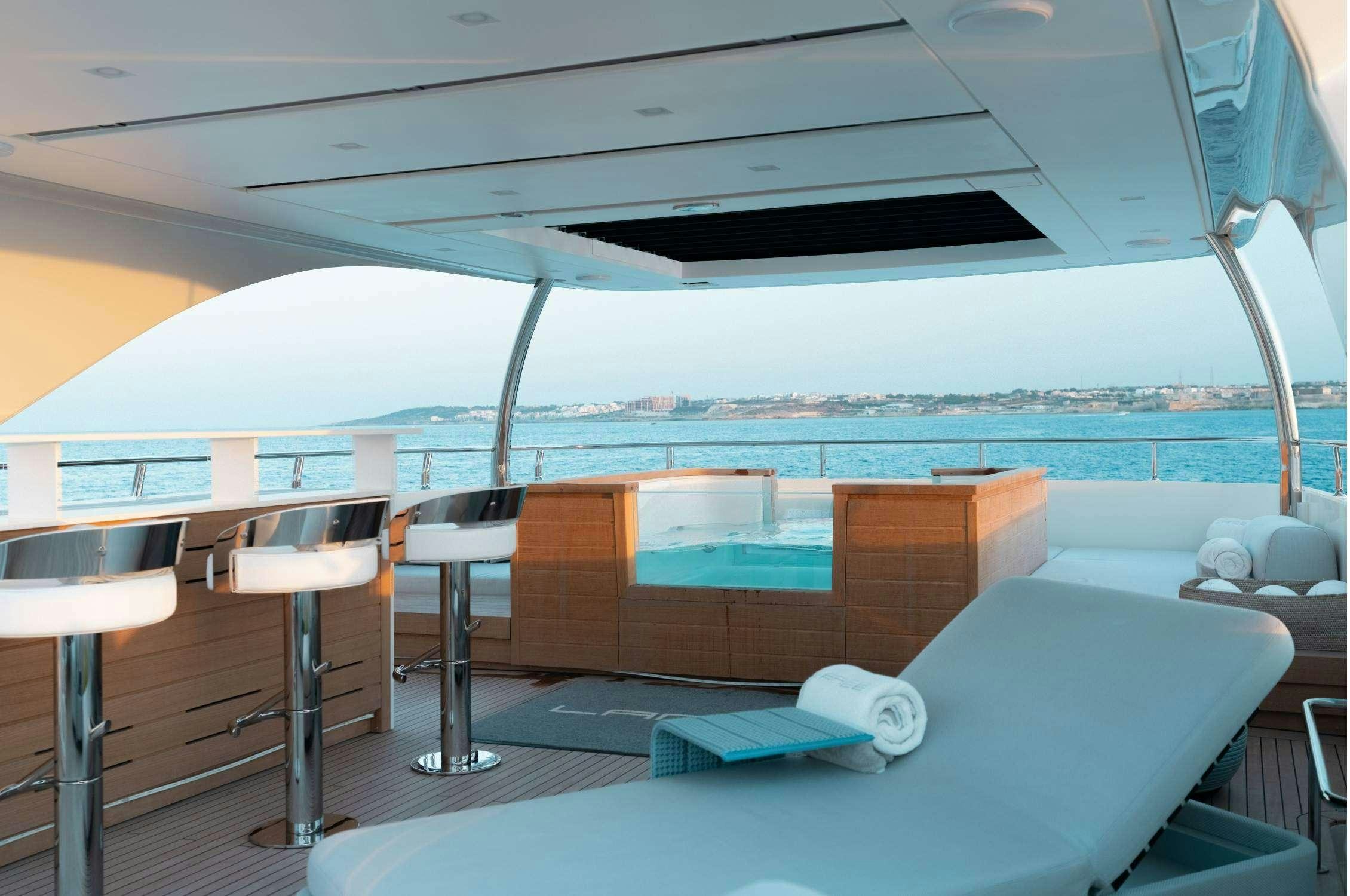 a room with a bed and a table and chairs aboard LANCE Yacht for Charter