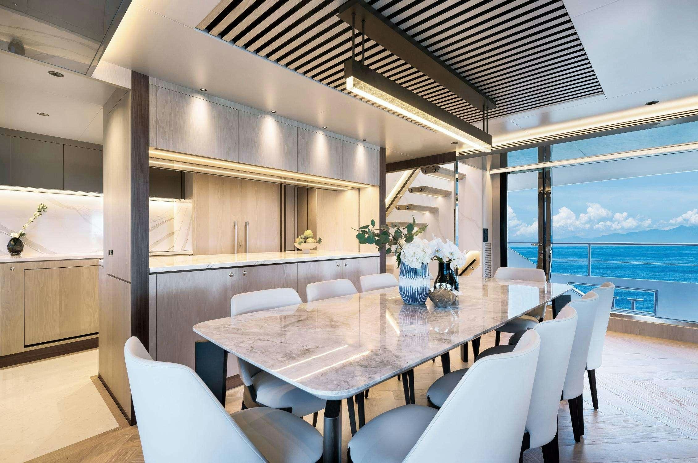 a dining room with a large window aboard AURA Yacht for Charter