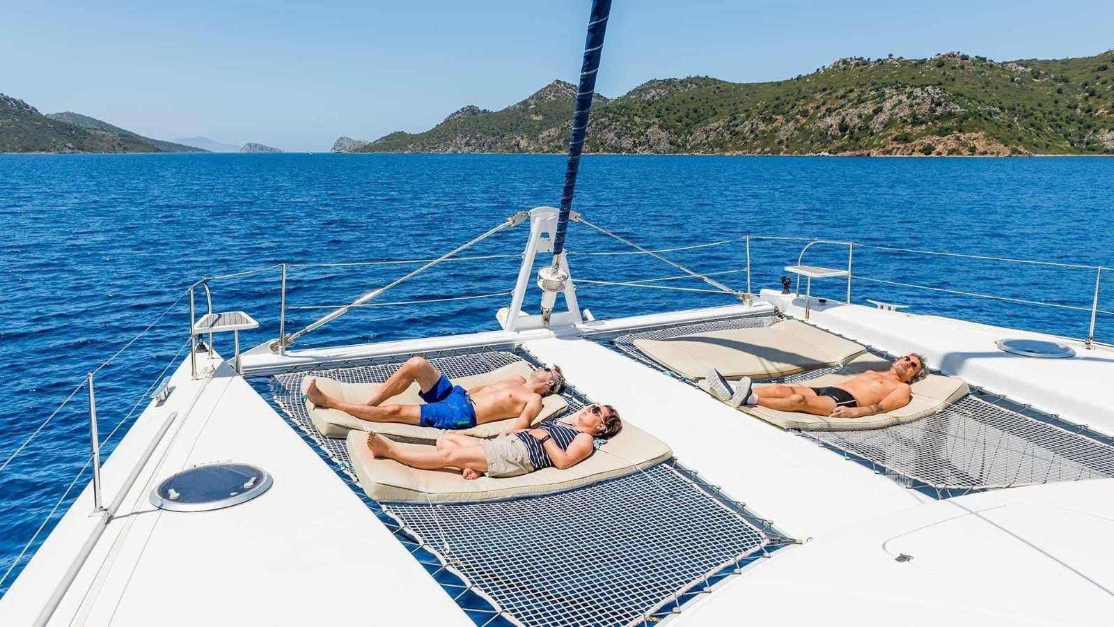 a person lying on a boat aboard ZORBA CAT Yacht for Charter