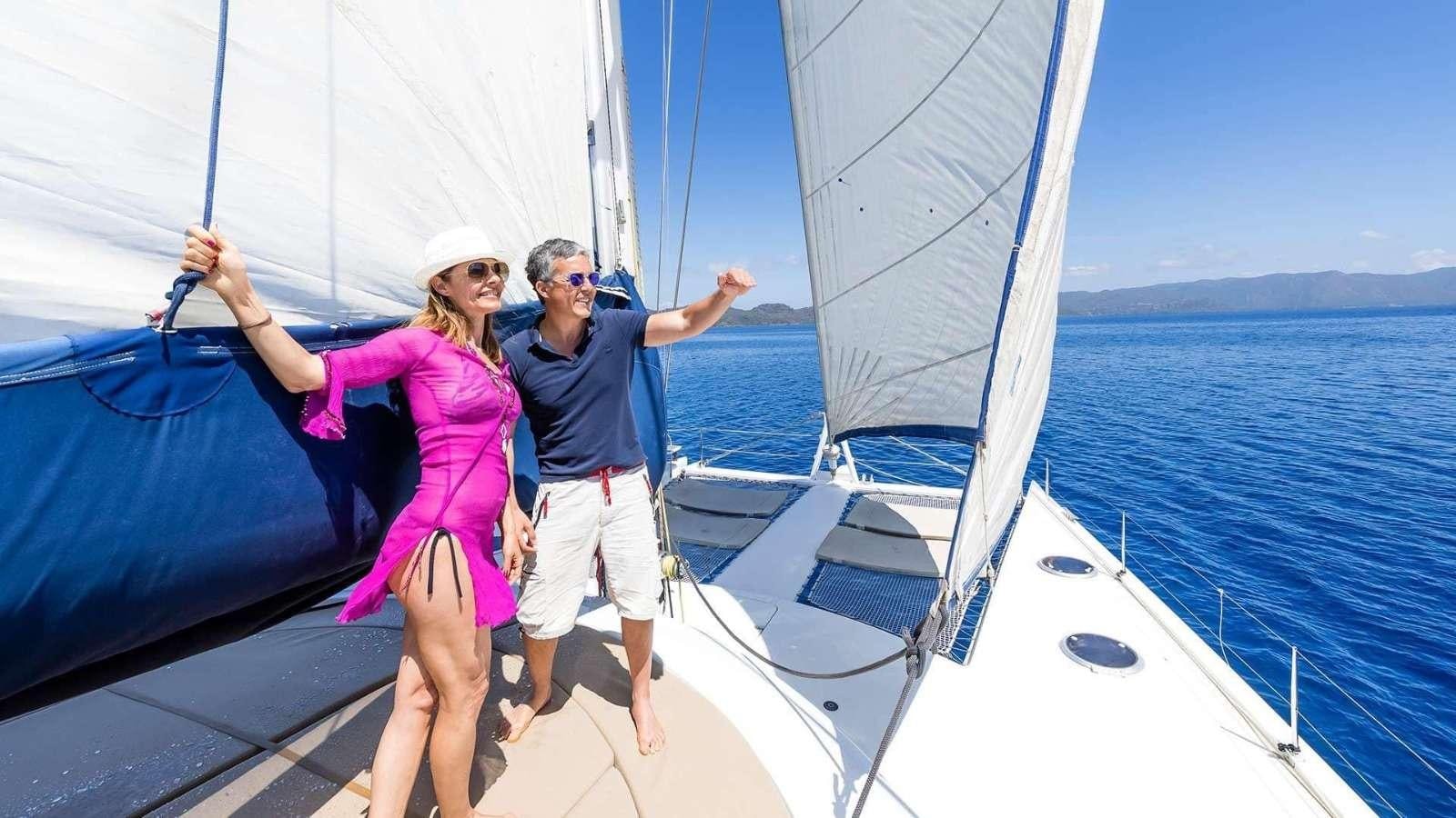 a man and woman on a sailboat aboard ZORBA CAT Yacht for Charter