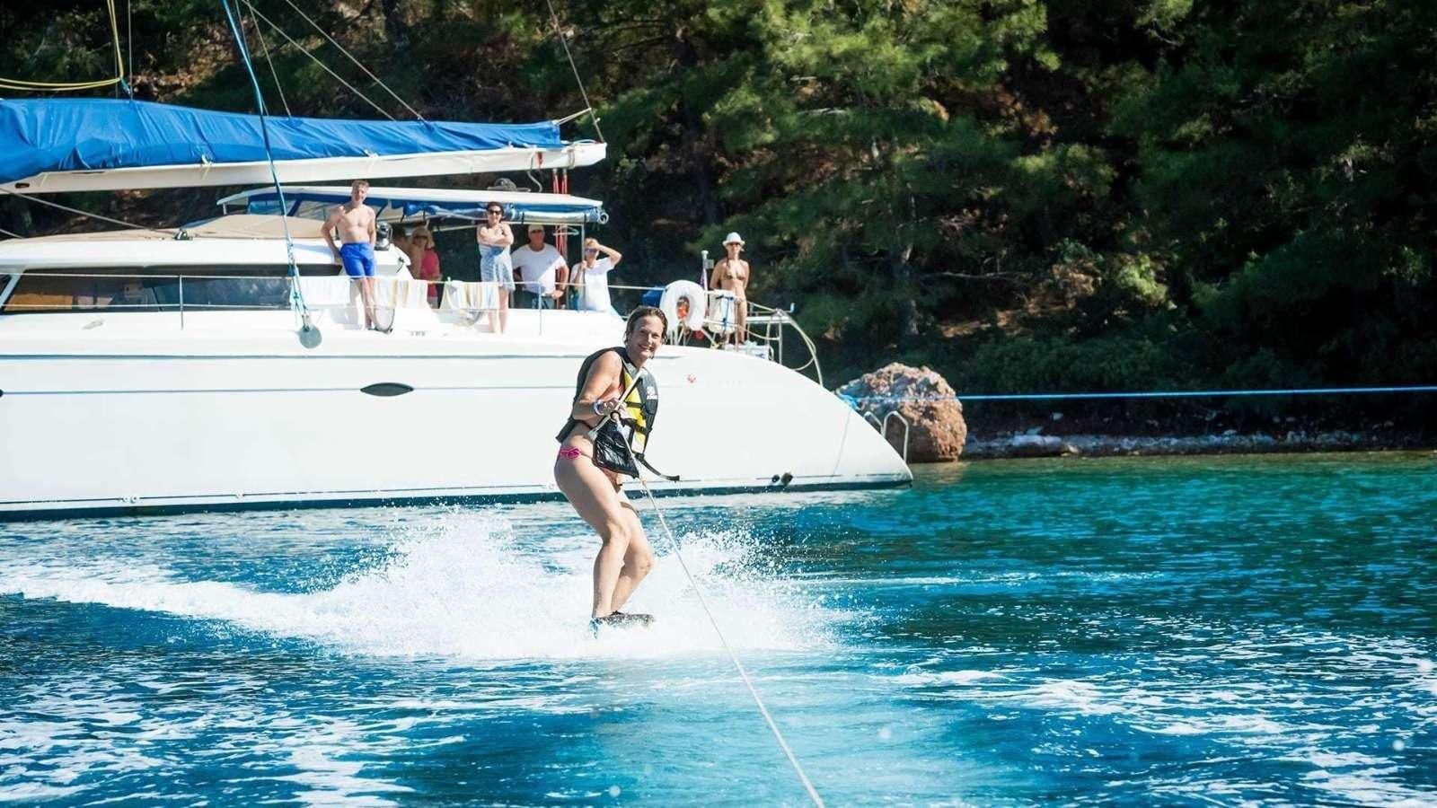a man water skiing aboard ZORBA CAT Yacht for Charter