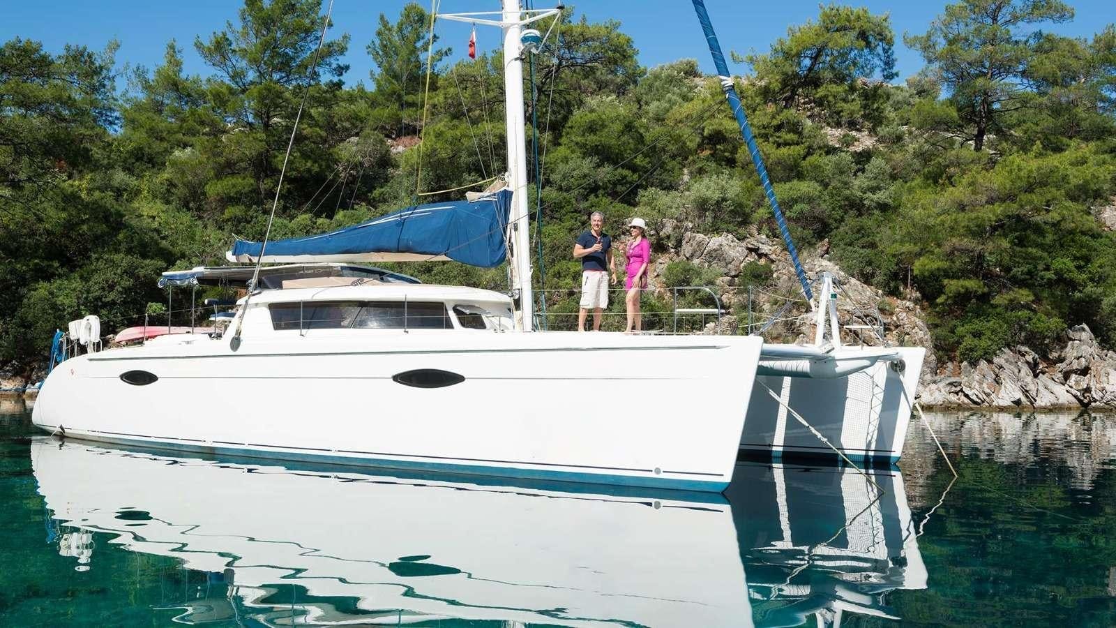 a couple of people standing on a boat in the water aboard ZORBA CAT Yacht for Charter