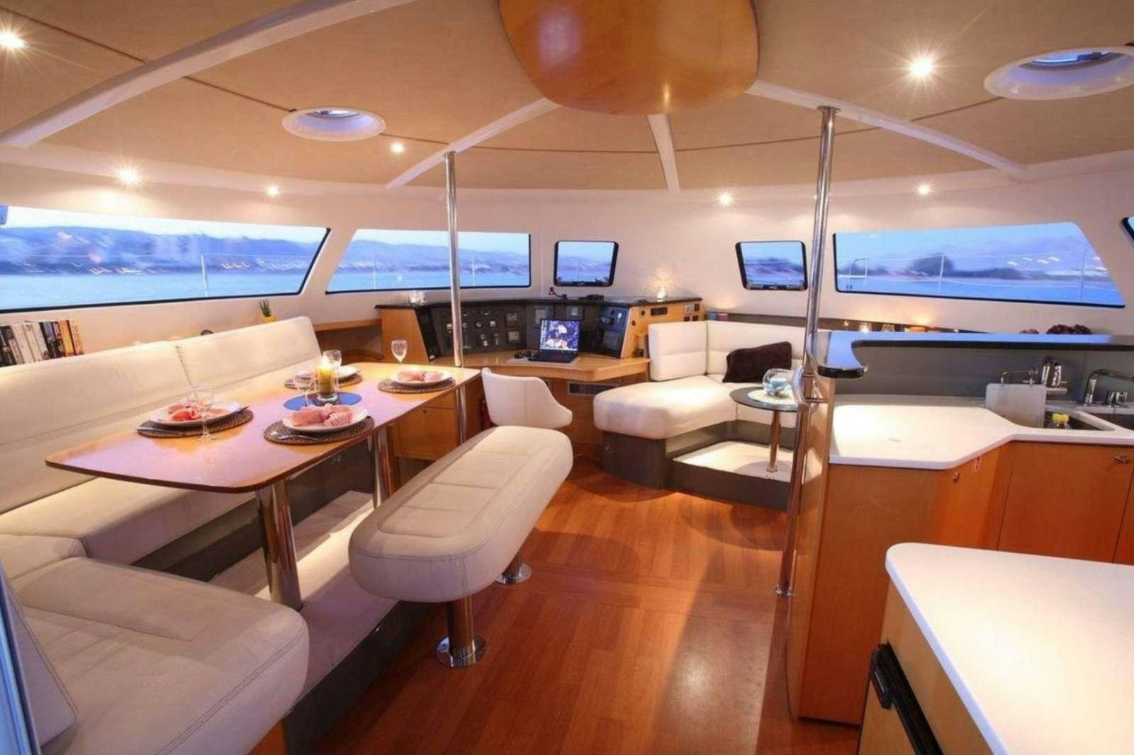 a room with tables and chairs aboard ZORBA CAT Yacht for Charter