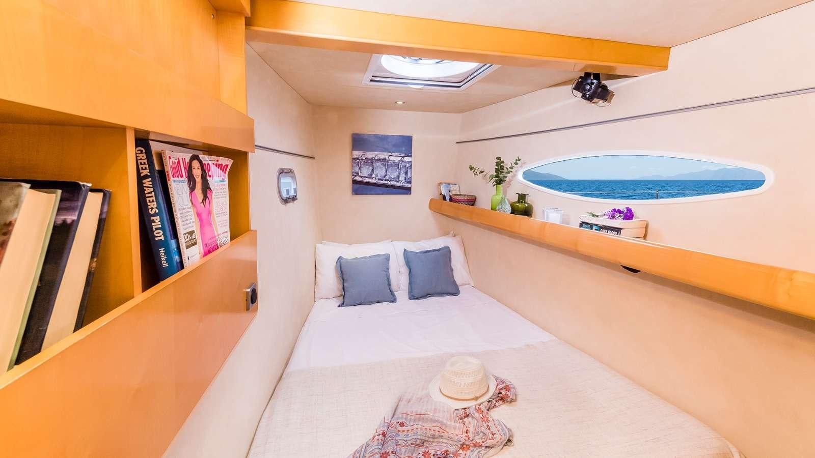 a room with a bed and a table aboard ZORBA CAT Yacht for Charter