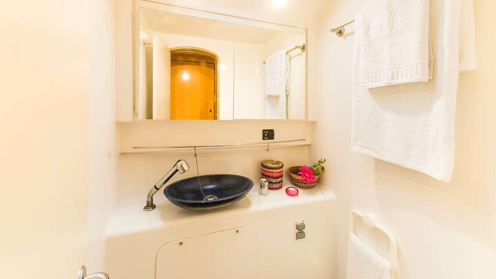 a bathroom with a sink and mirror aboard ZORBA CAT Yacht for Charter