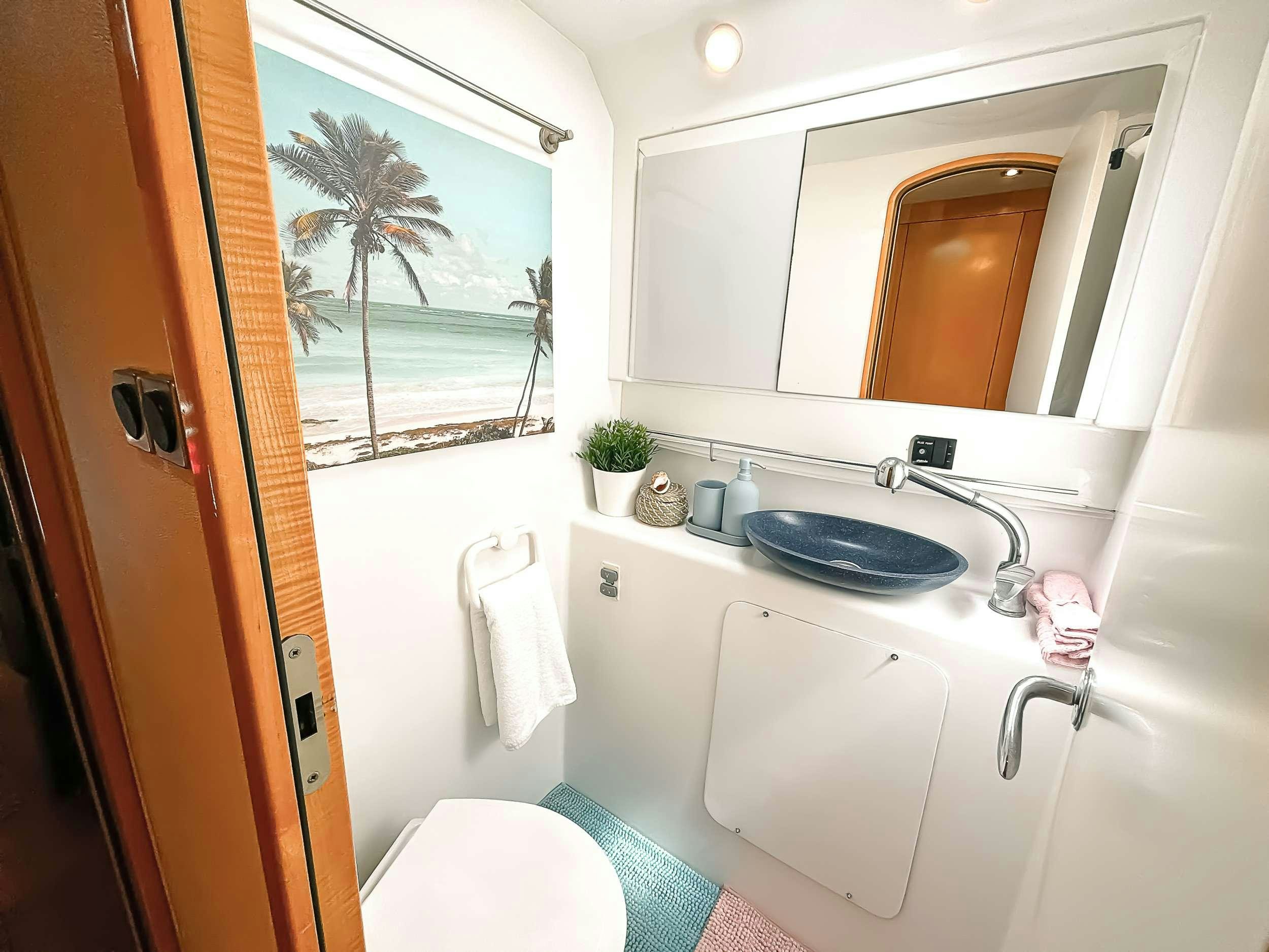 a bathroom with a sink and a mirror aboard ZORBA CAT Yacht for Charter