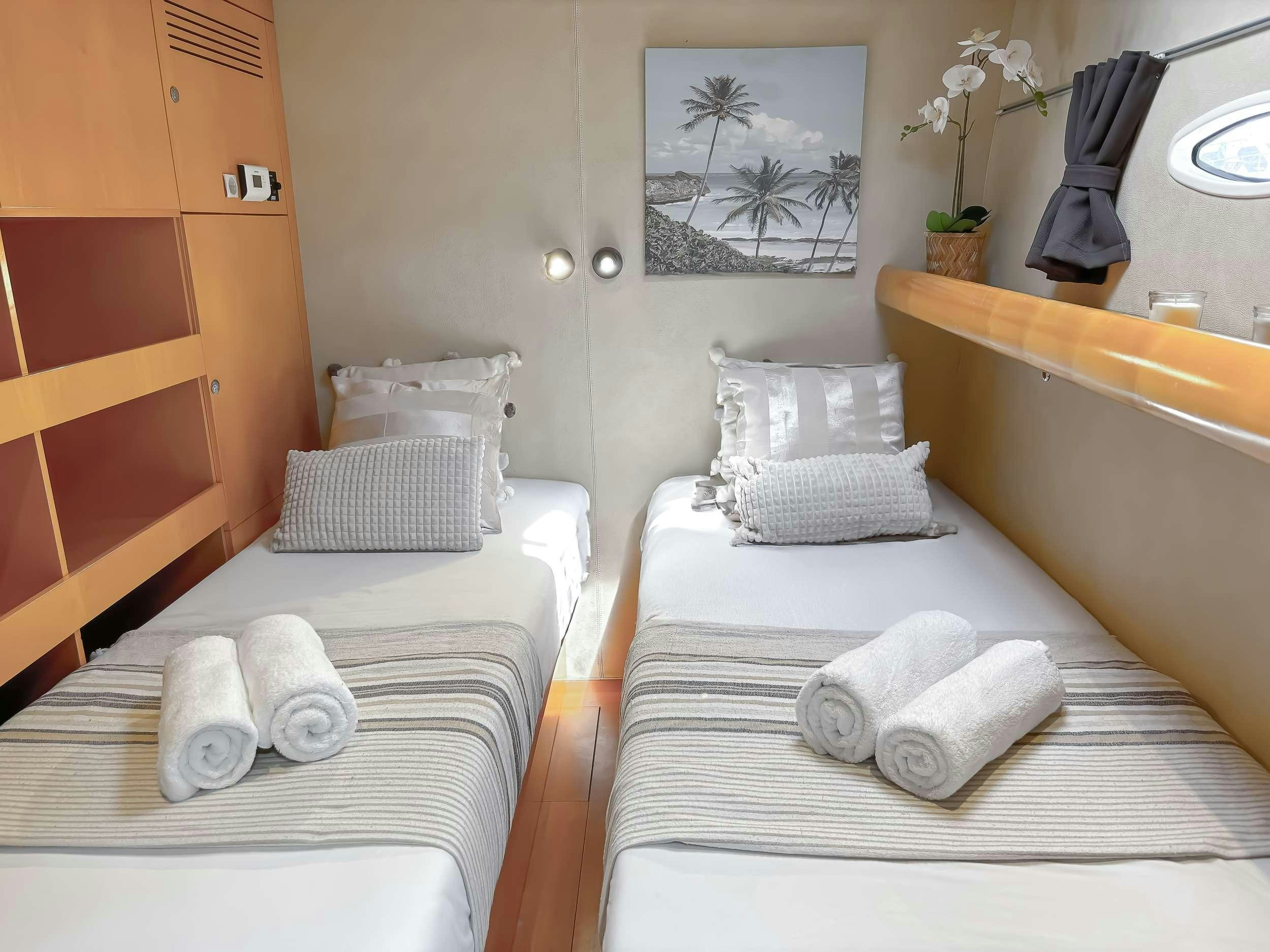 a couple of beds in a room aboard ZORBA CAT Yacht for Charter