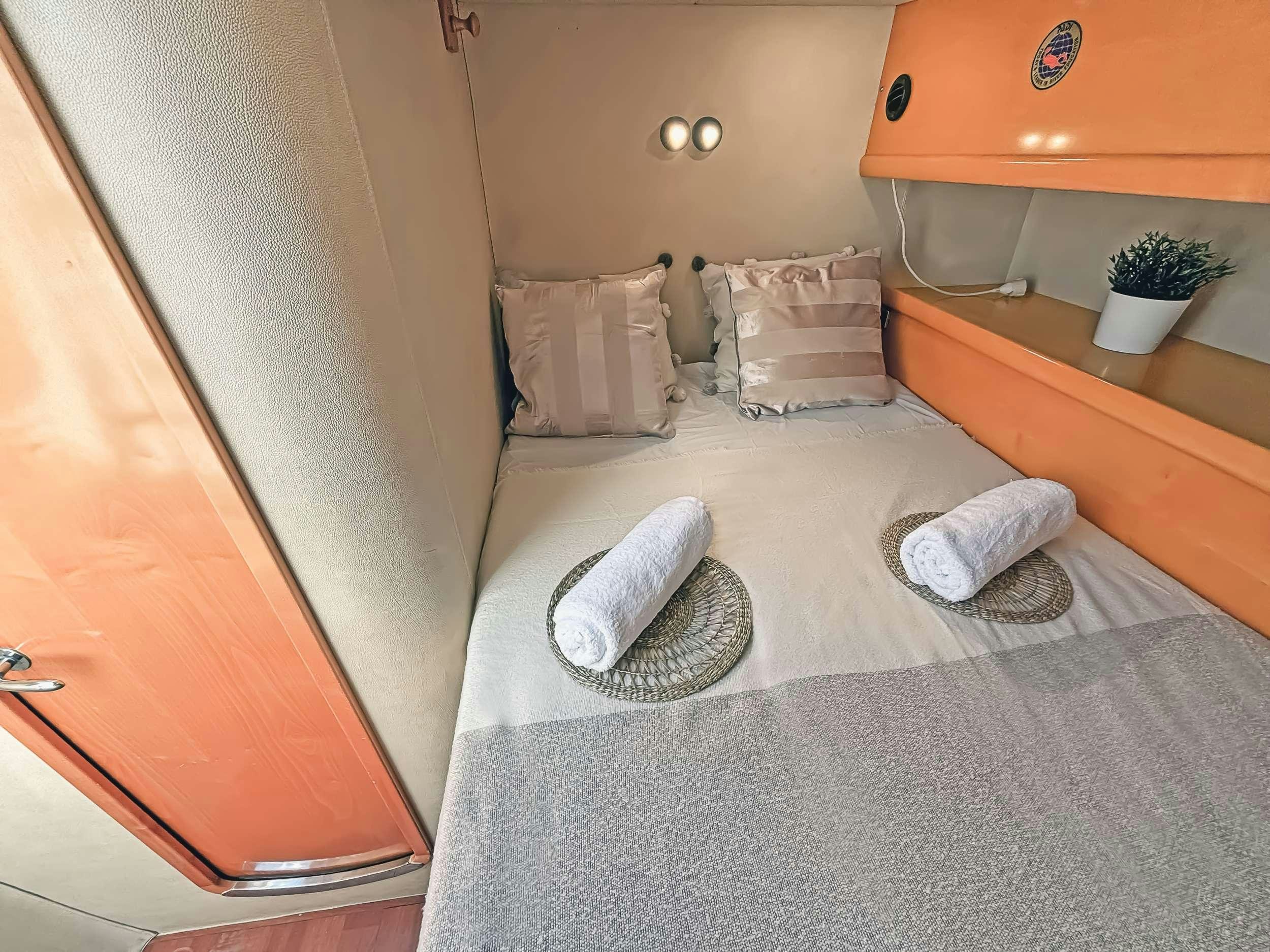 a bed with a towel on it aboard ZORBA CAT Yacht for Charter