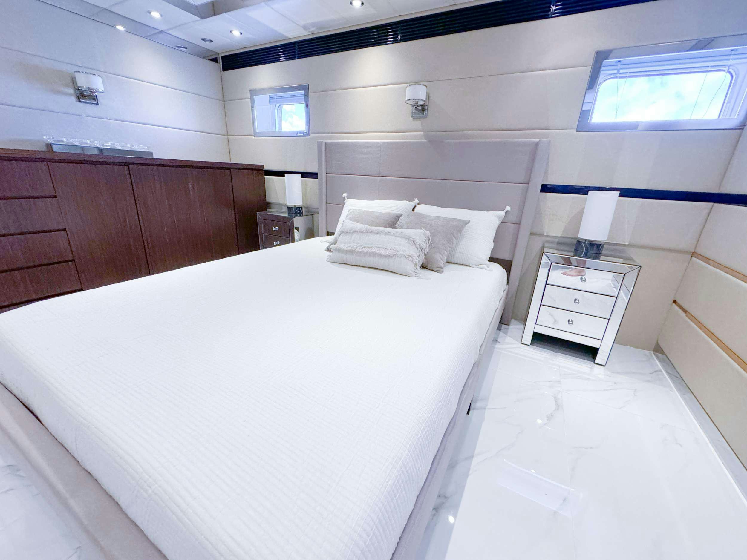 a white bed in a room aboard PRIVILEGE Yacht for Charter