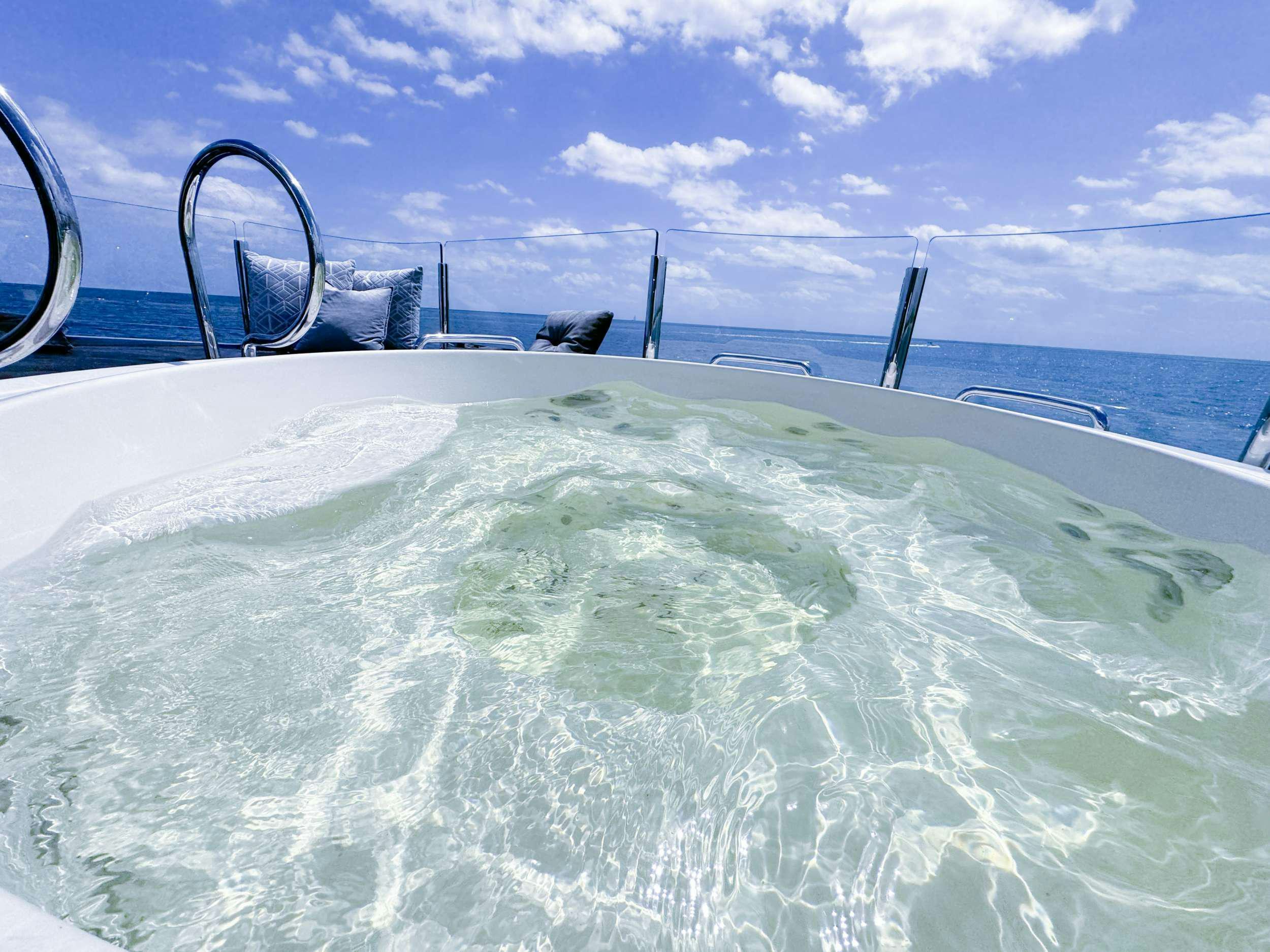 a large white pool with blue water aboard PRIVILEGE Yacht for Charter