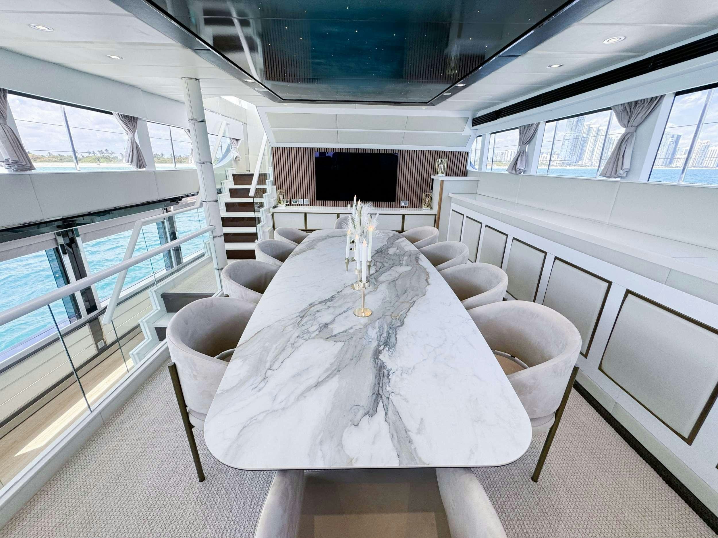 a dining room with a chandelier aboard PRIVILEGE Yacht for Charter