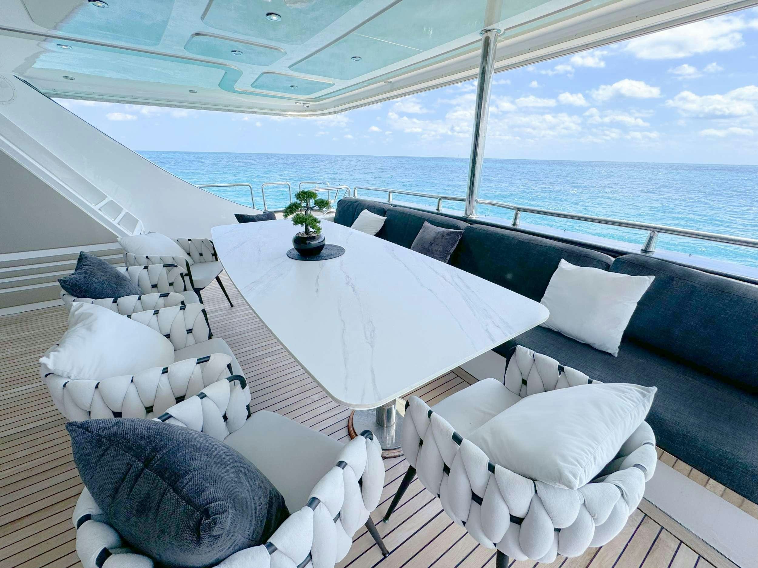a large white lounge chair on a deck overlooking the ocean aboard PRIVILEGE Yacht for Charter