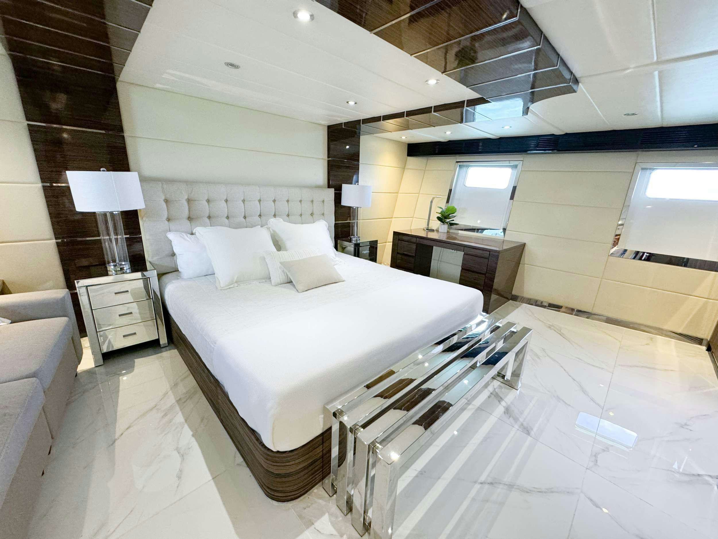a room with a bed and a desk aboard PRIVILEGE Yacht for Charter