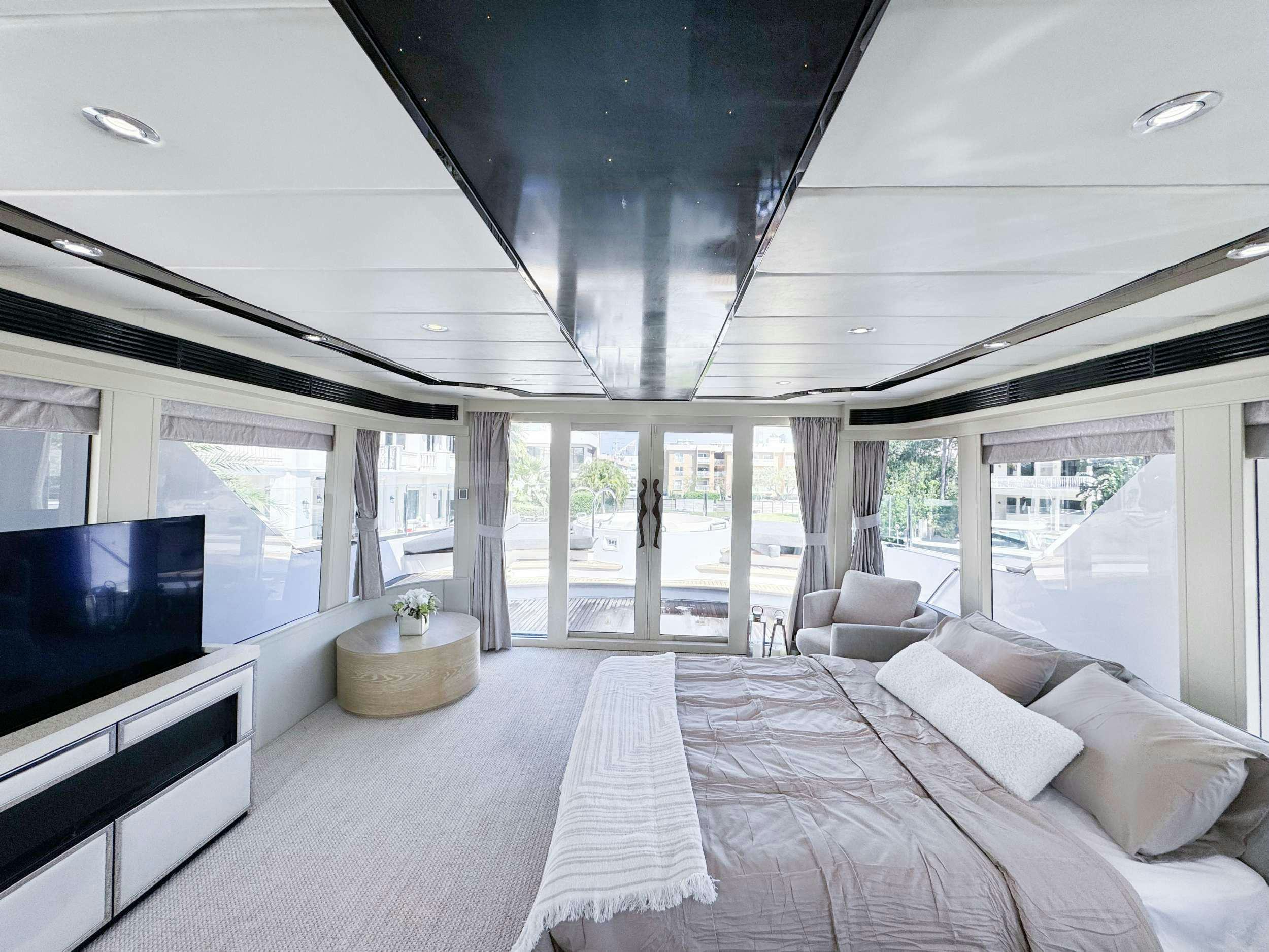 a large bedroom with a large open window aboard PRIVILEGE Yacht for Charter