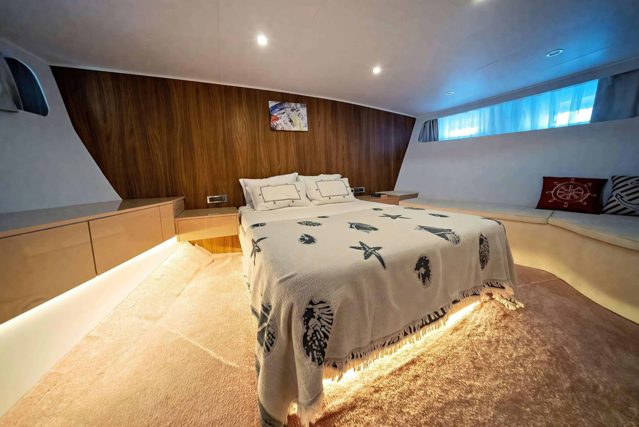 a room with a bed and a desk aboard S4 Yacht for Charter