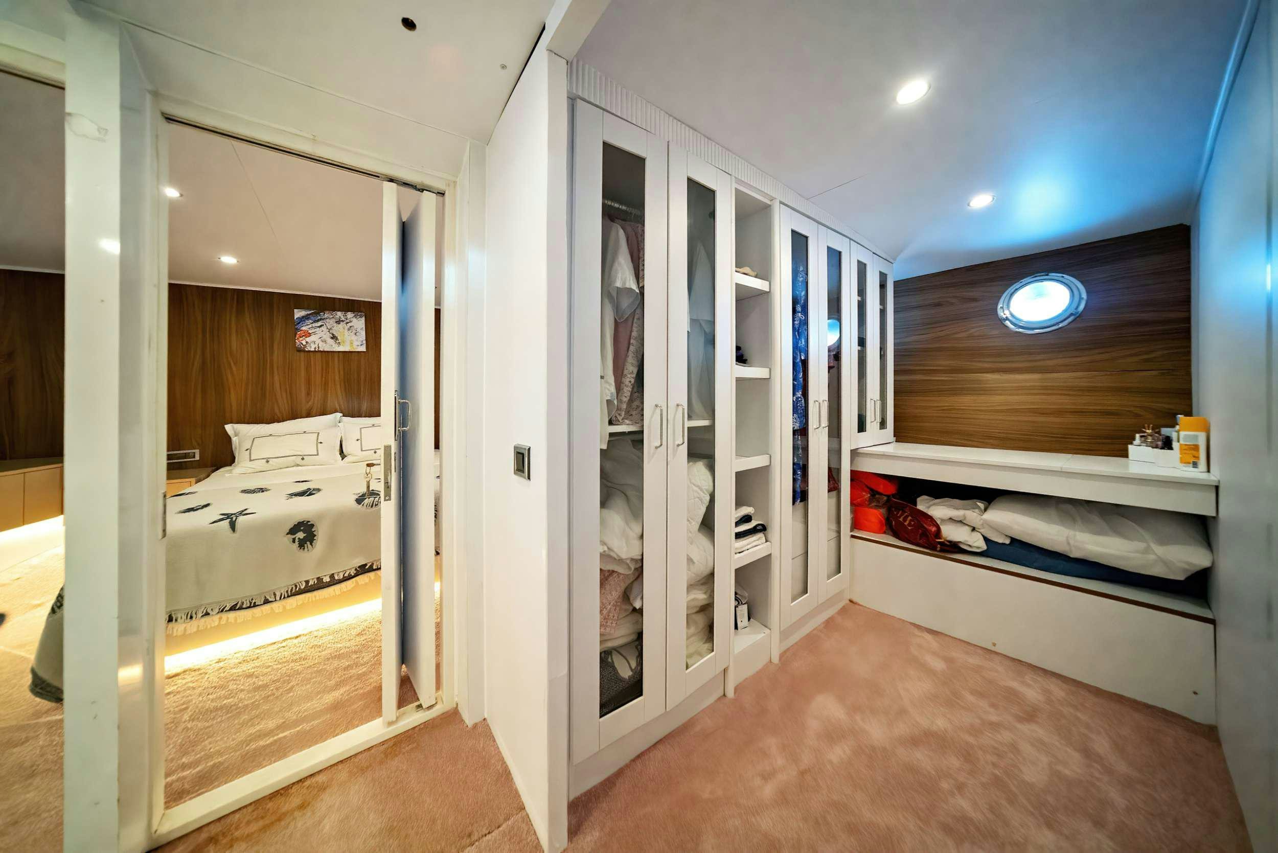 a room with a bed and a mirror aboard S4 Yacht for Charter