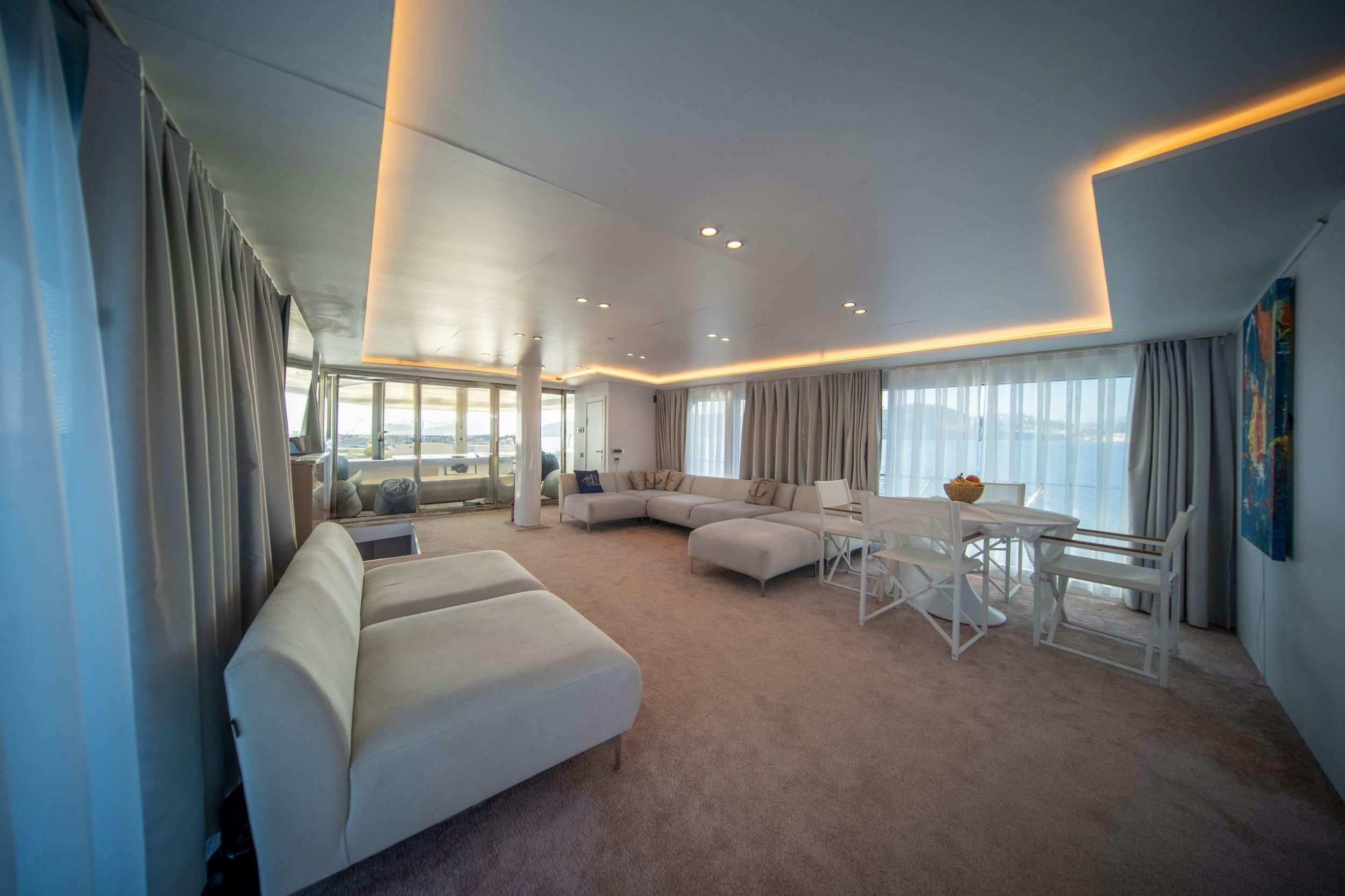 a living room with a couch and a table aboard S4 Yacht for Charter