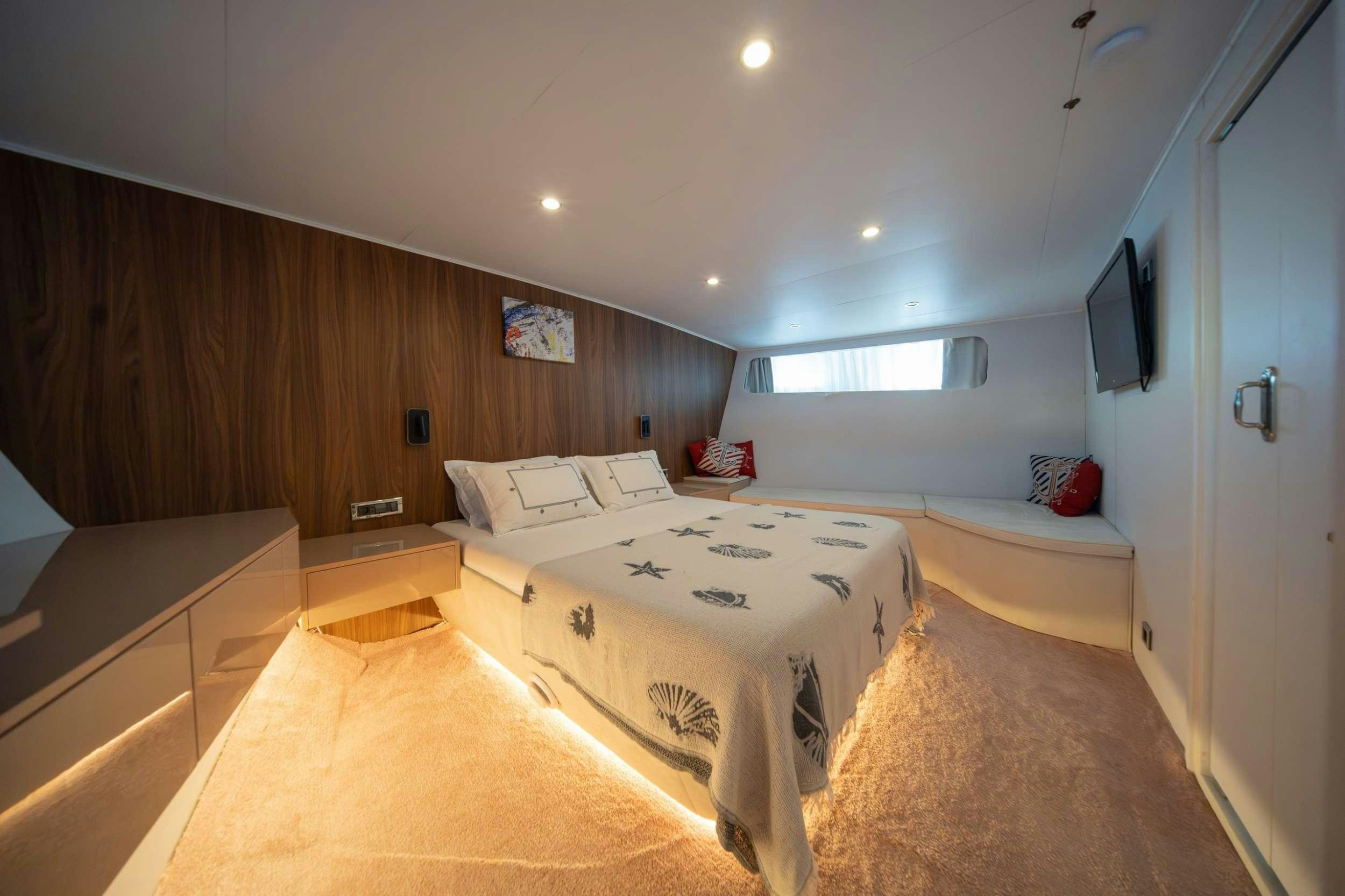 a room with a couple of beds aboard S4 Yacht for Charter