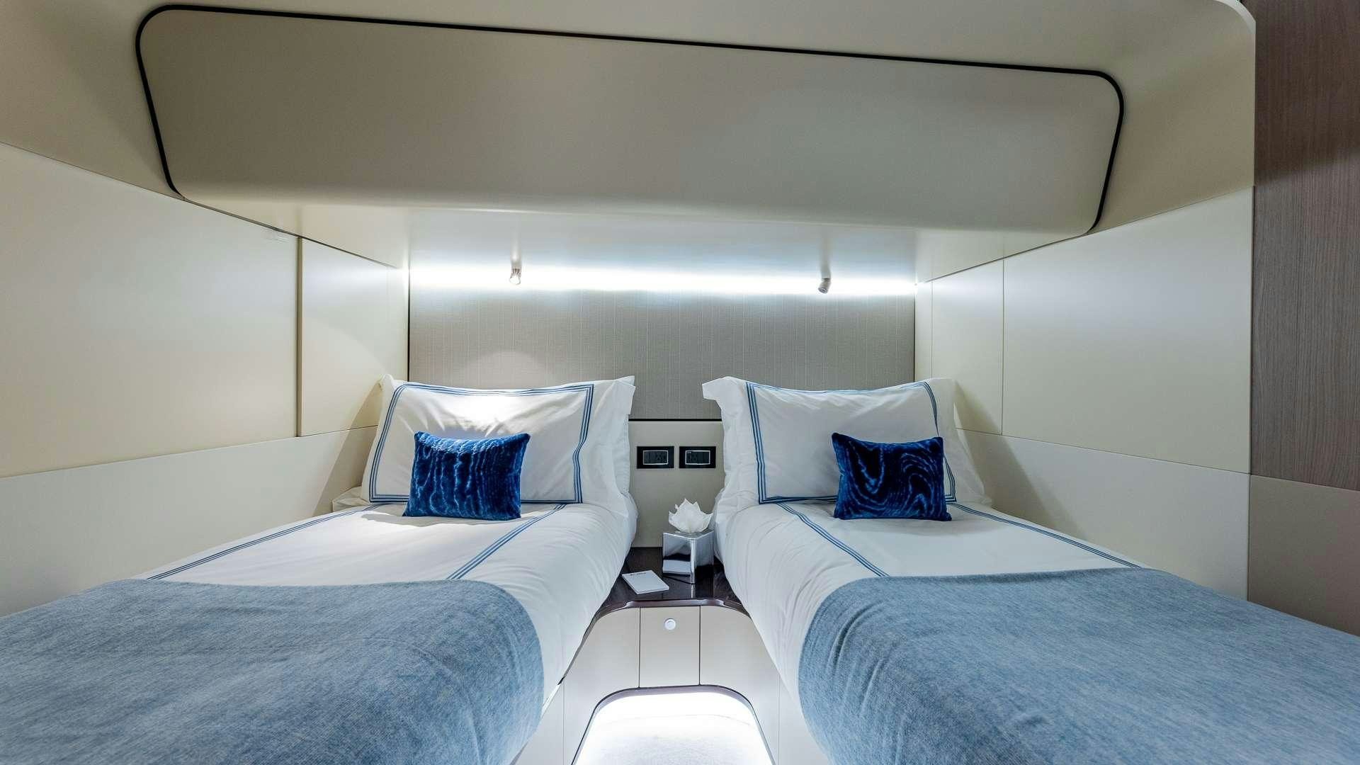 a couple of beds in a room aboard 4 PLAY Yacht for Charter