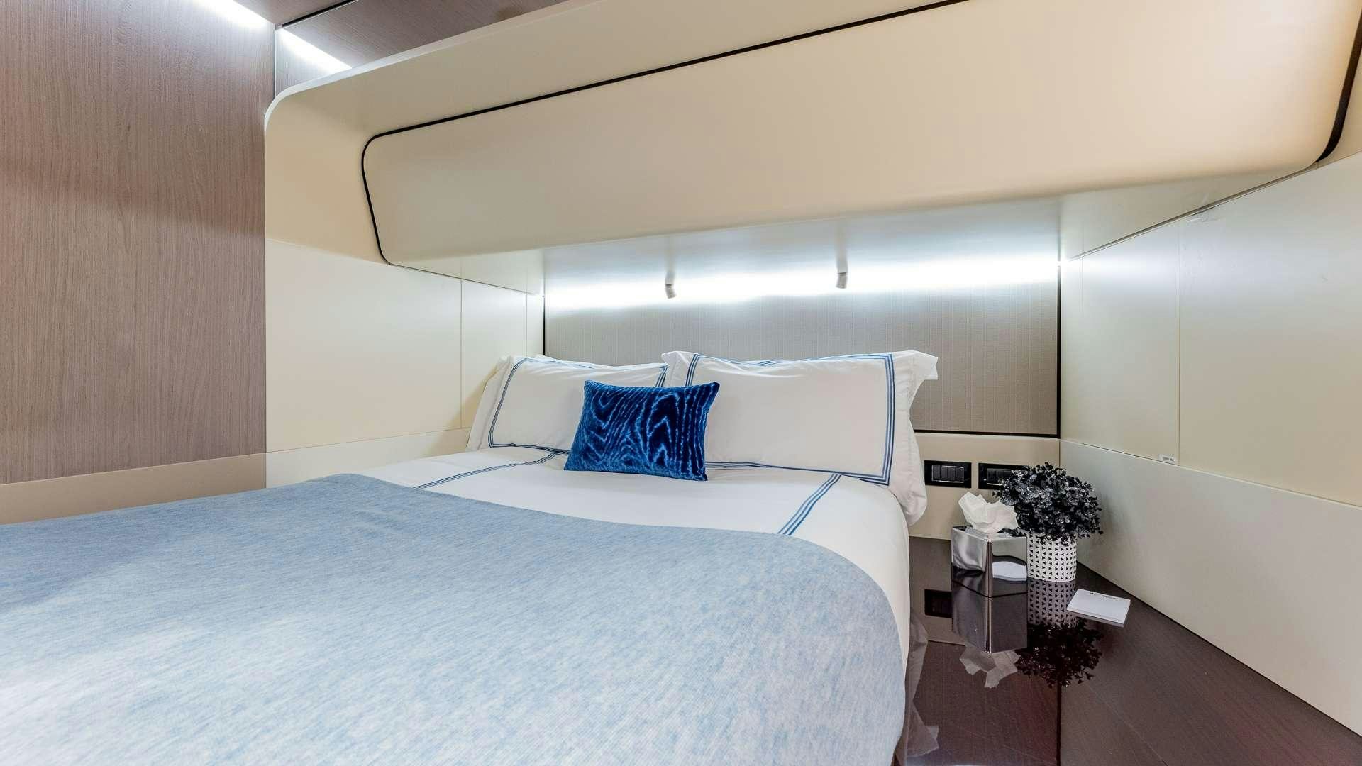 a bed with white sheets aboard 4 PLAY Yacht for Charter