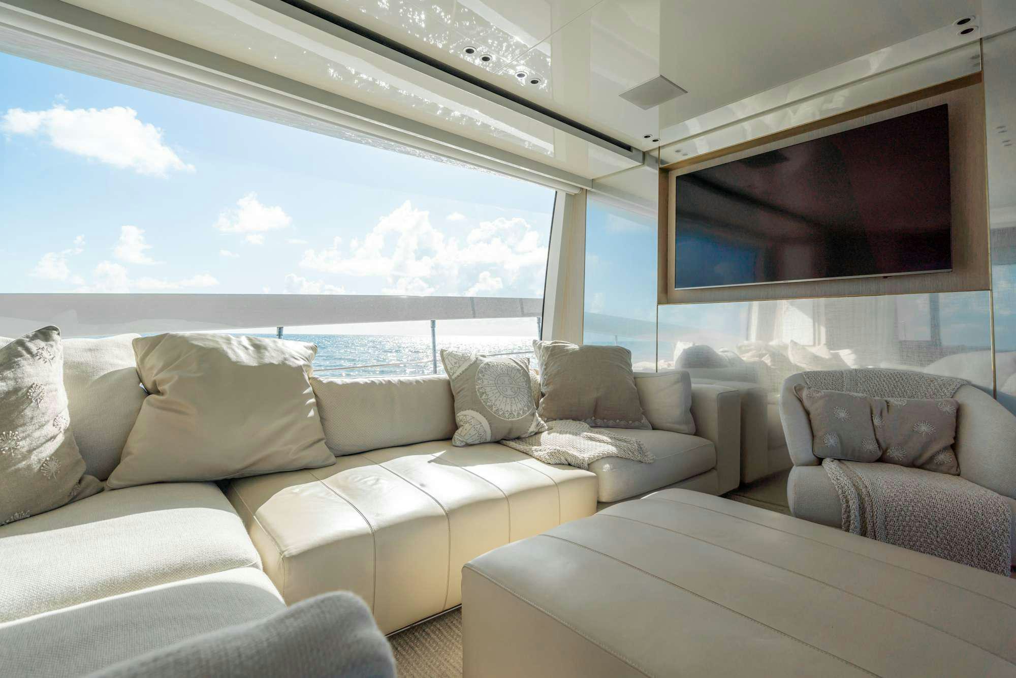 a living room with a large window aboard QUARANTENA Yacht for Charter