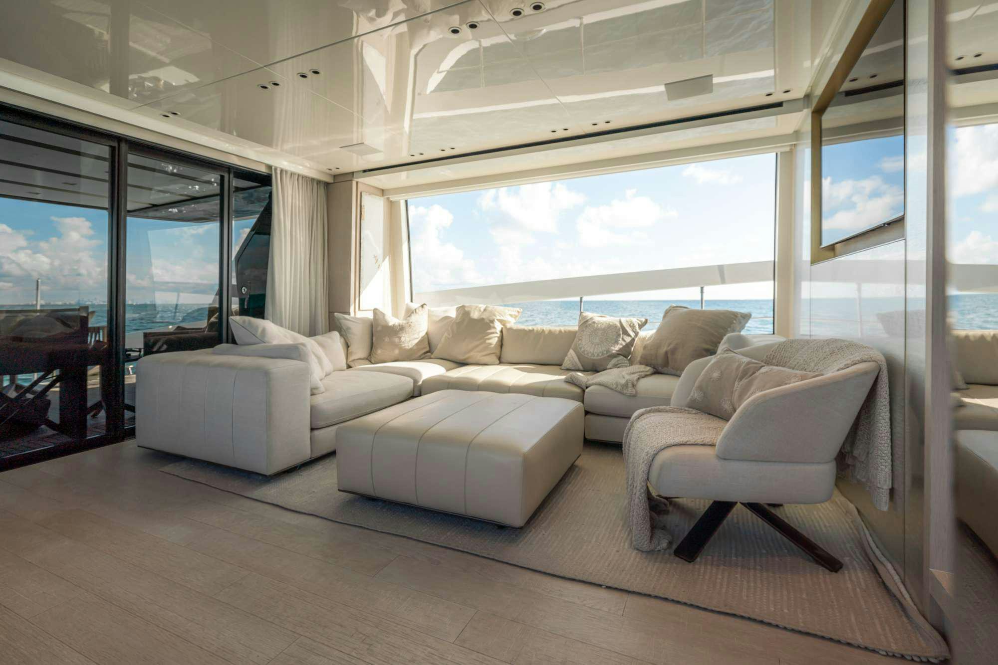 a living room with a large window aboard QUARANTENA Yacht for Charter