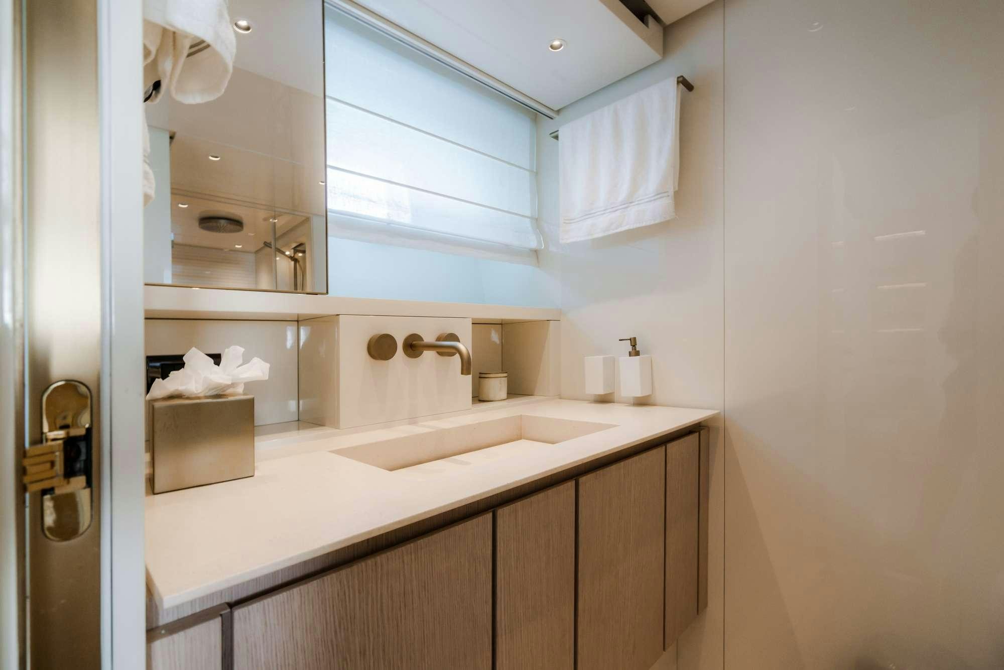 a bathroom with a sink and a mirror aboard QUARANTENA Yacht for Charter