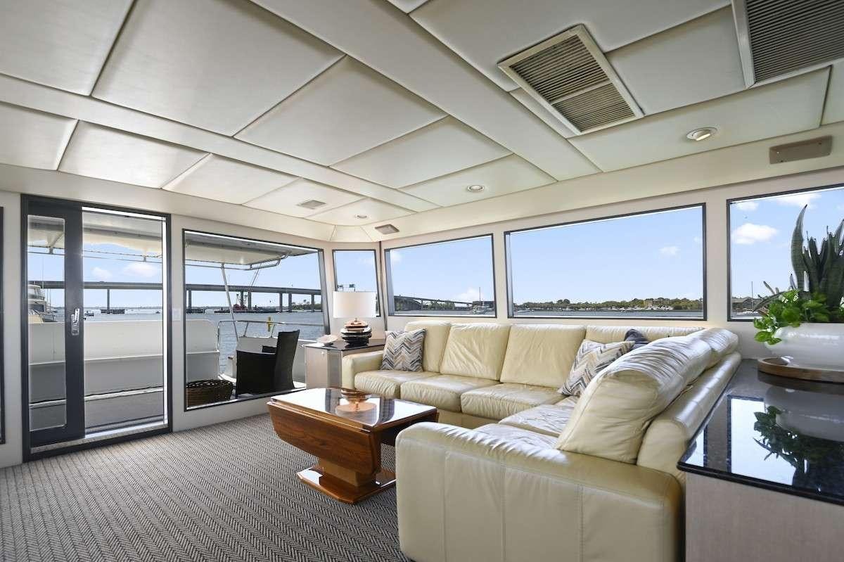 a living room with a large window aboard MISS EMILY Yacht for Charter