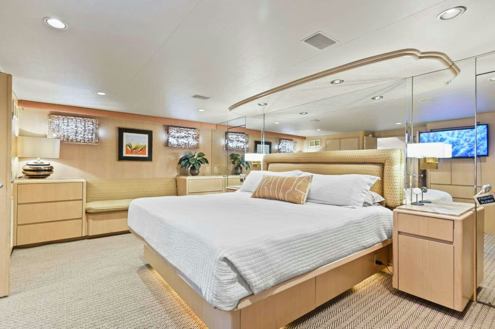 a bedroom with a bed and a desk aboard MISS EMILY Yacht for Charter