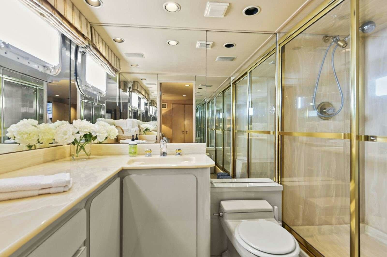 a bathroom with a glass shower aboard MISS EMILY Yacht for Charter