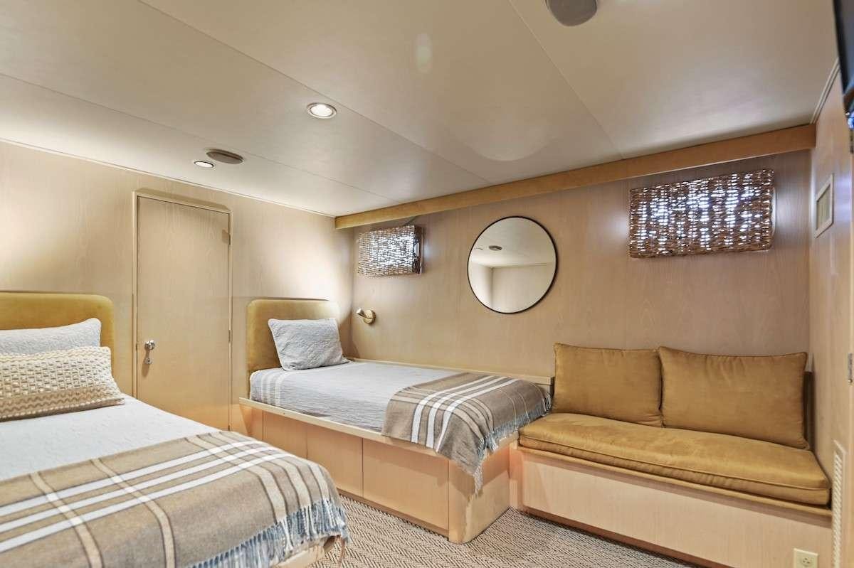 a bedroom with a bed and a couch aboard MISS EMILY Yacht for Charter