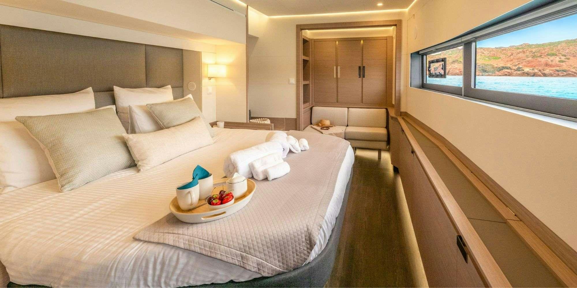a bed with a tray of food on it aboard SEMPER FIDELIS Yacht for Charter