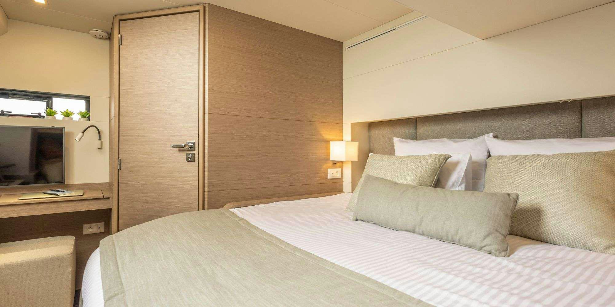 a bed with white sheets aboard SEMPER FIDELIS Yacht for Charter