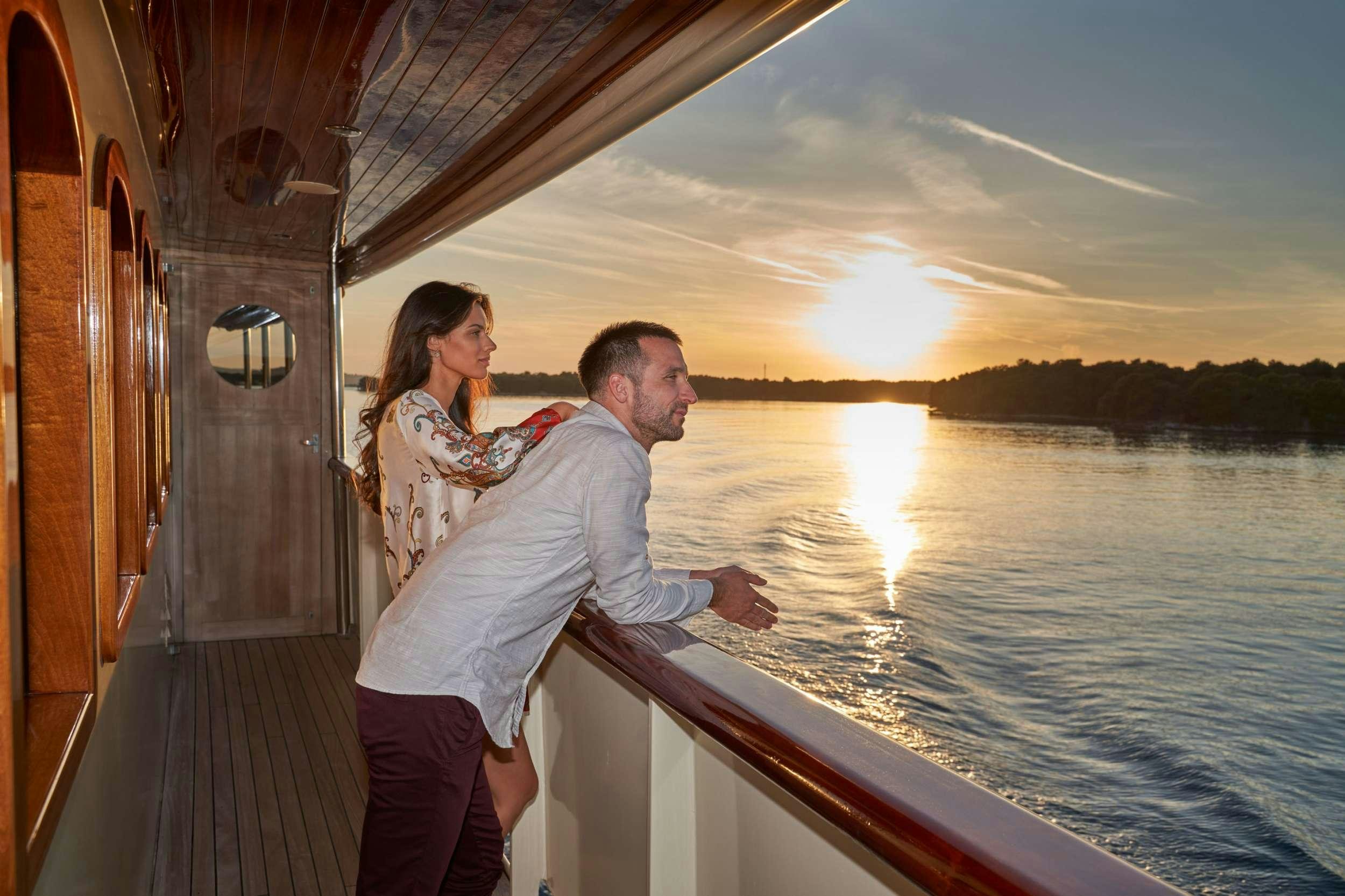 a man and woman kissing on a boat aboard CASABLANCA Yacht for Charter