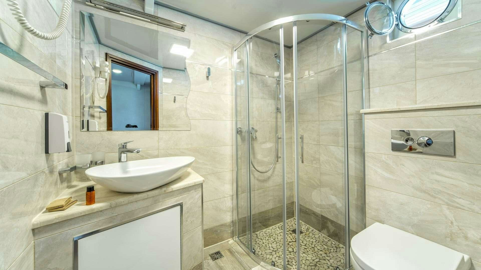 a bathroom with a glass shower aboard CASABLANCA Yacht for Charter