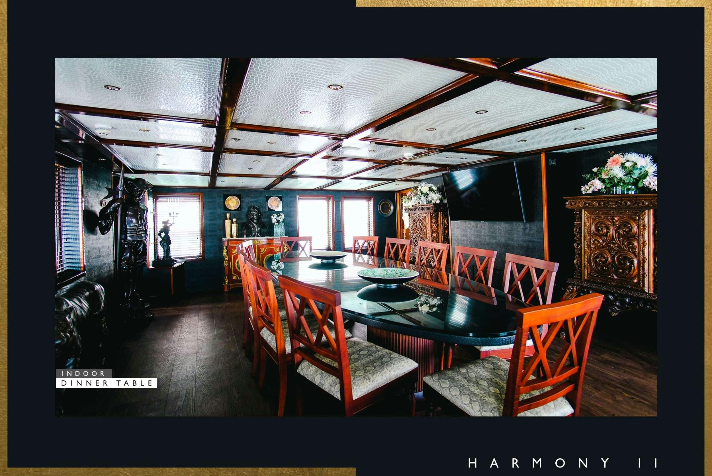 a room with a table and chairs aboard HARMONY II Yacht for Charter