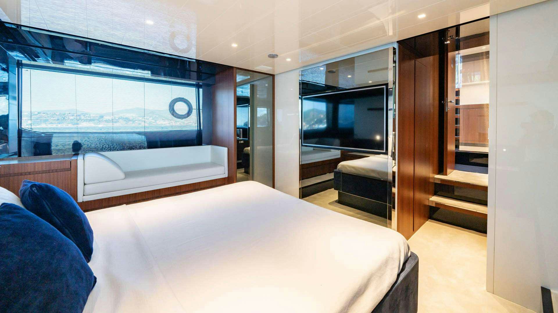 a room with a bed and a large window aboard BLUE SHARK Yacht for Charter
