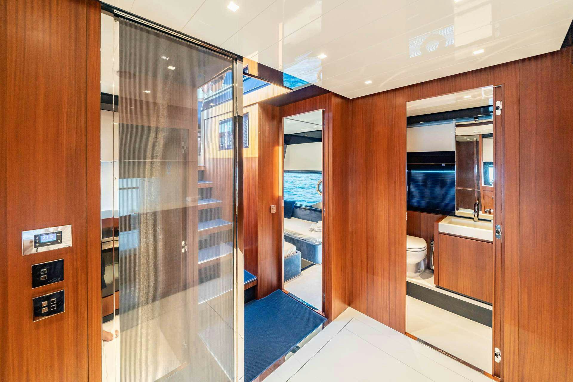 a bathroom with a glass shower aboard BLUE SHARK Yacht for Charter