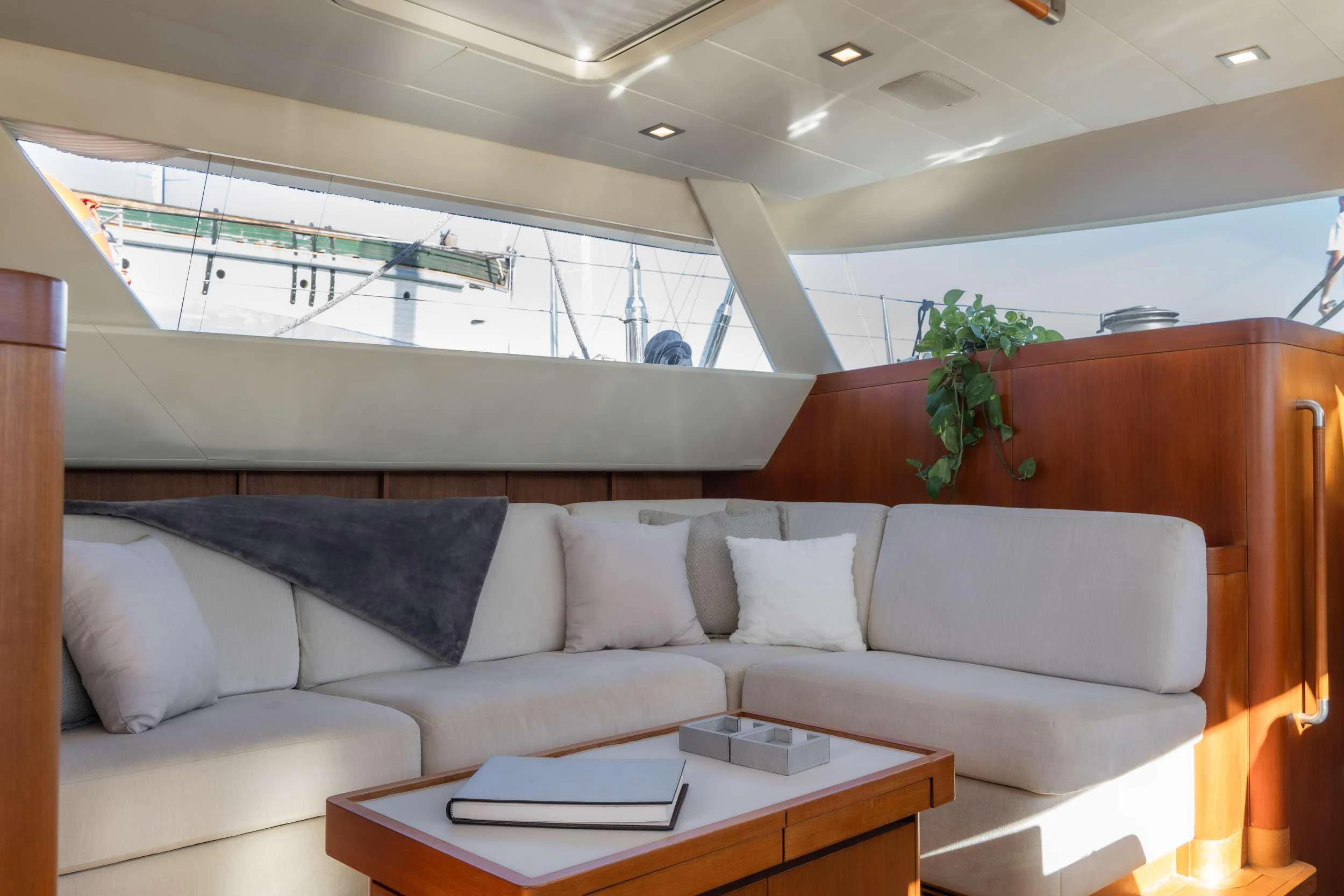 a living room with a couch and a coffee table aboard VARSOVIE Yacht for Charter