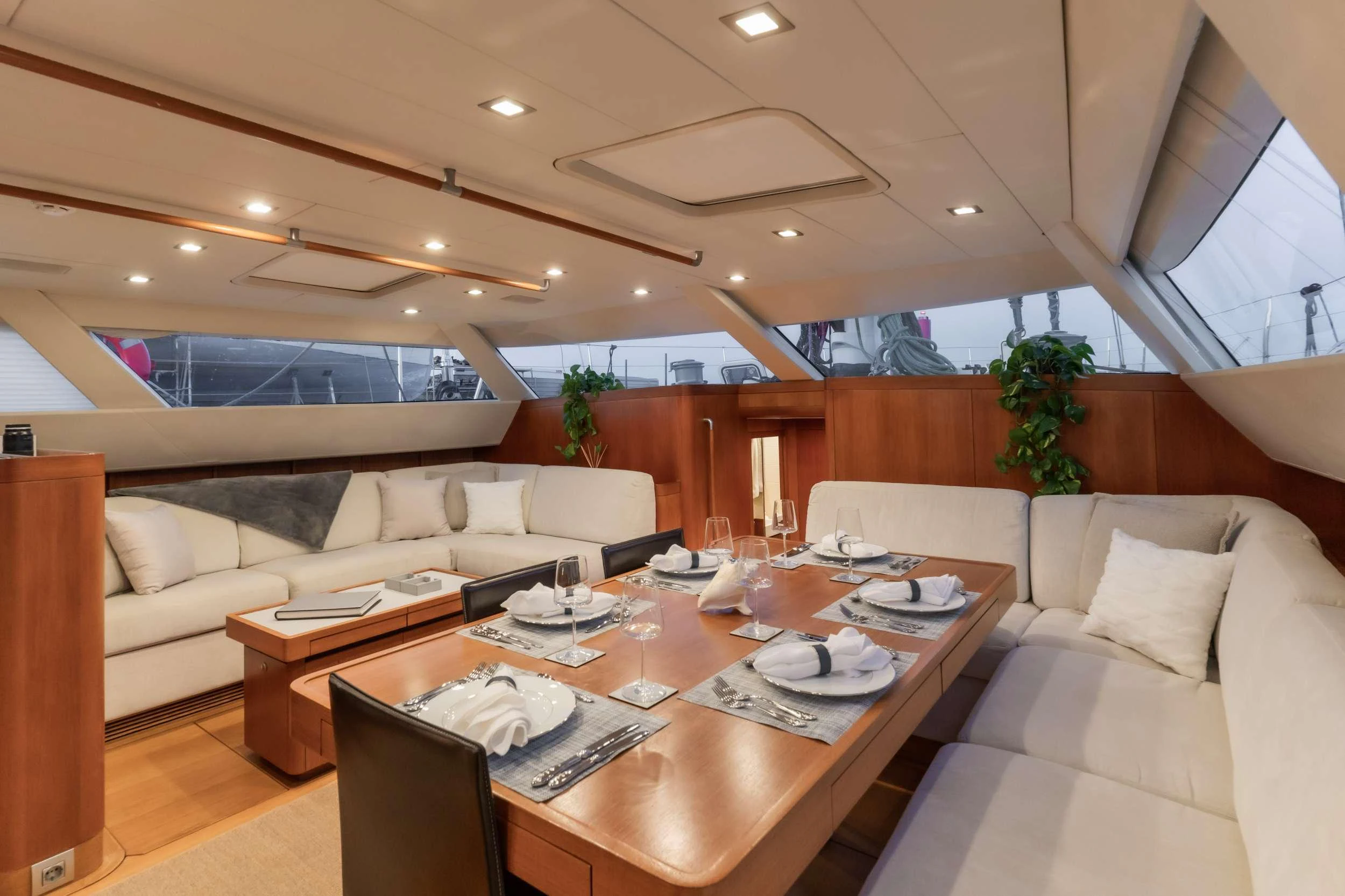 a living room with a table and couches aboard VARSOVIE Yacht for Charter