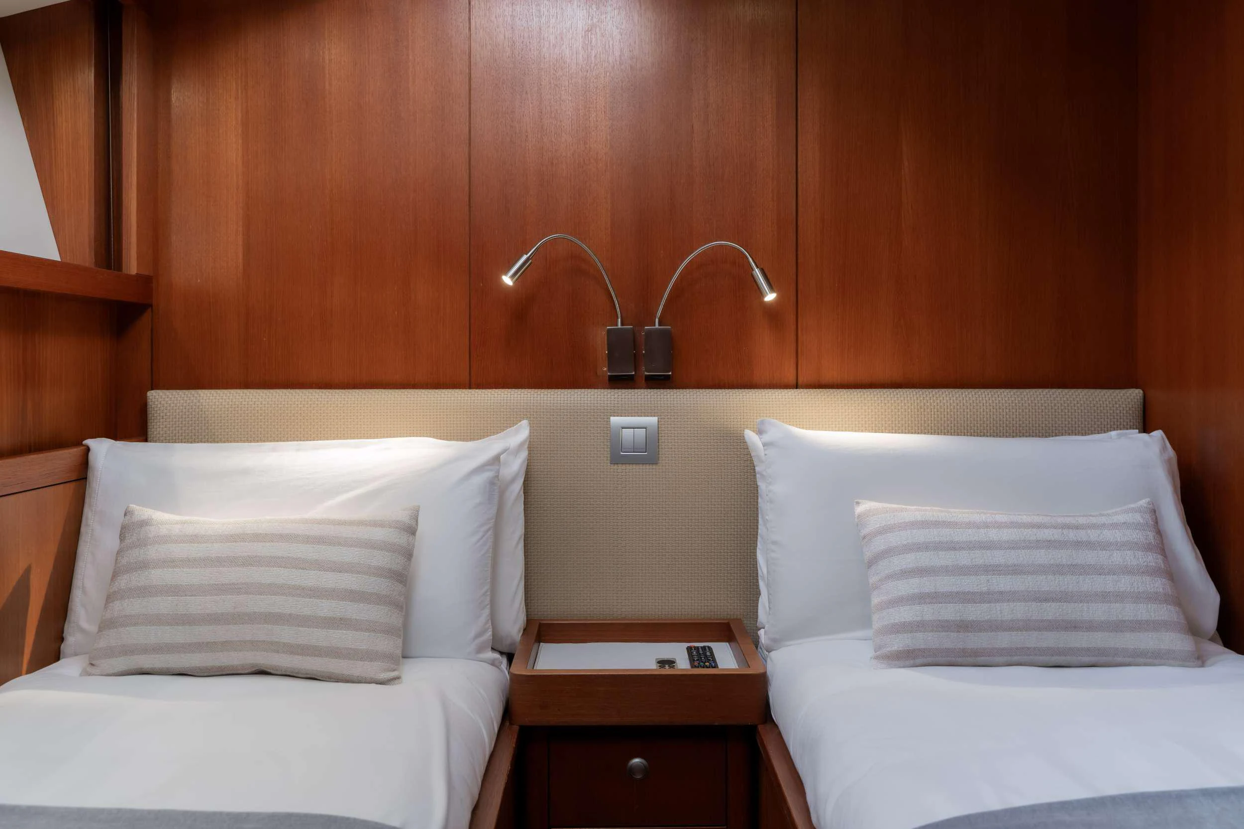 a bed with white pillows aboard VARSOVIE Yacht for Charter