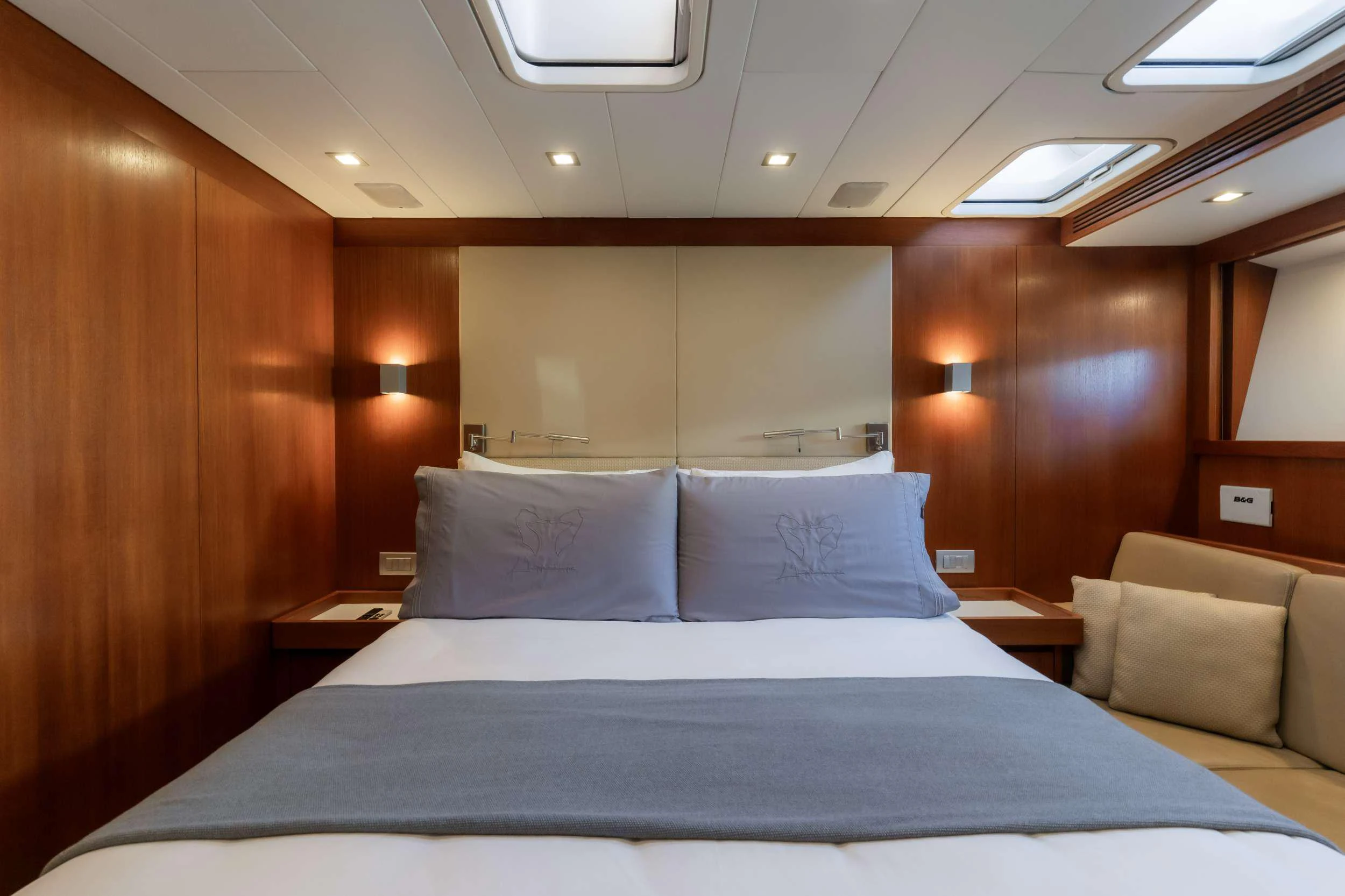 a bed with white sheets aboard VARSOVIE Yacht for Charter