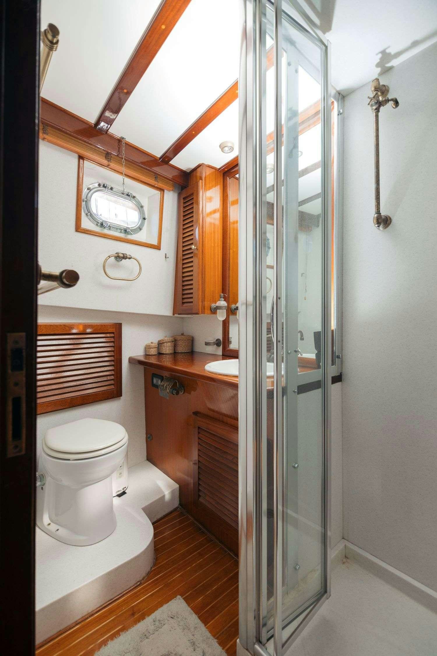 a bathroom with a shower unit and toilet aboard SEATZEN Yacht for Charter