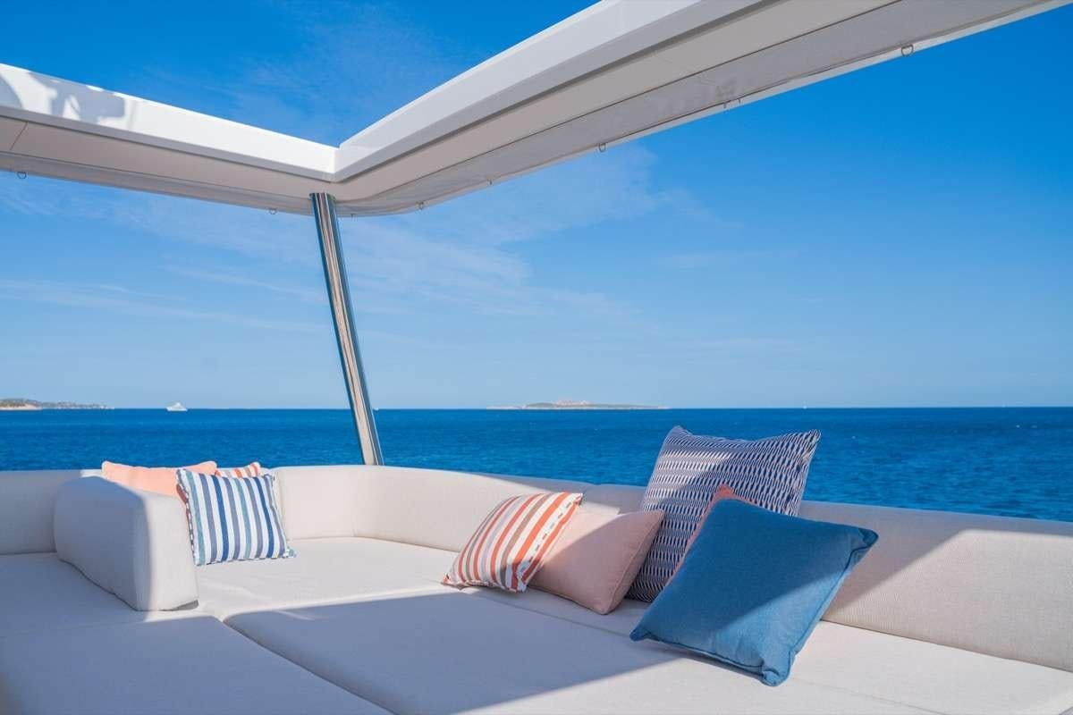 a white lounge chair on a white lounge chair on a beach aboard SEVENTY8 Yacht for Charter