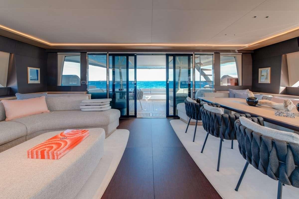 a room with a couch and a table and chairs aboard SEVENTY8 Yacht for Charter